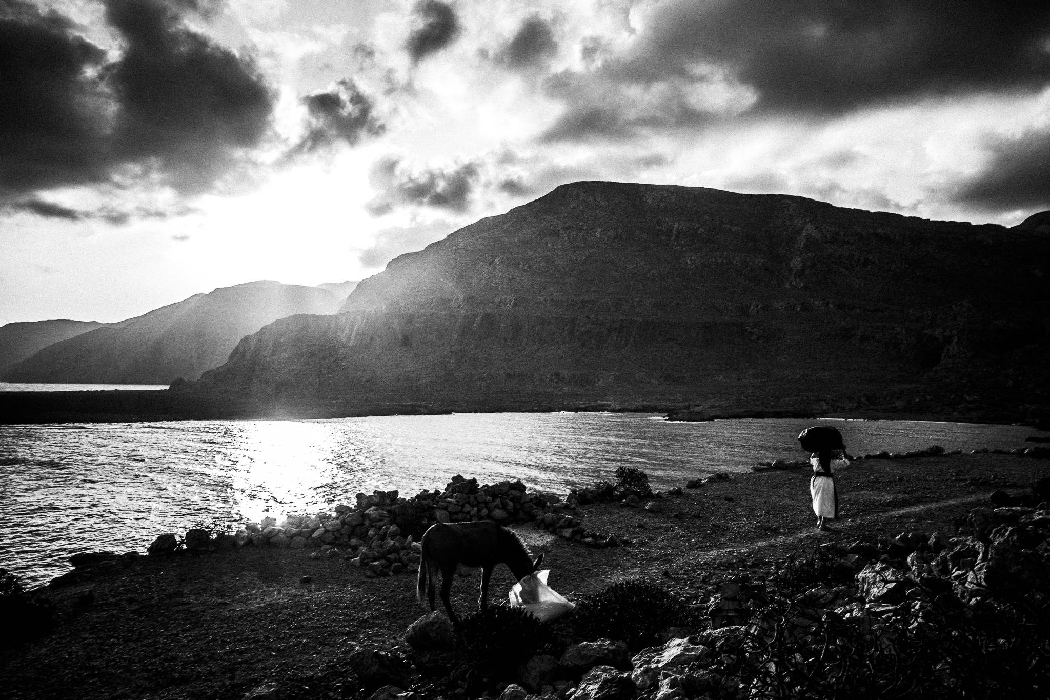 Leaving Vrykous after the feast of Saint John at the site of the ancient city of Brykous, Olympos, Karpathos, Greece. Black and white photography by George Tatakis