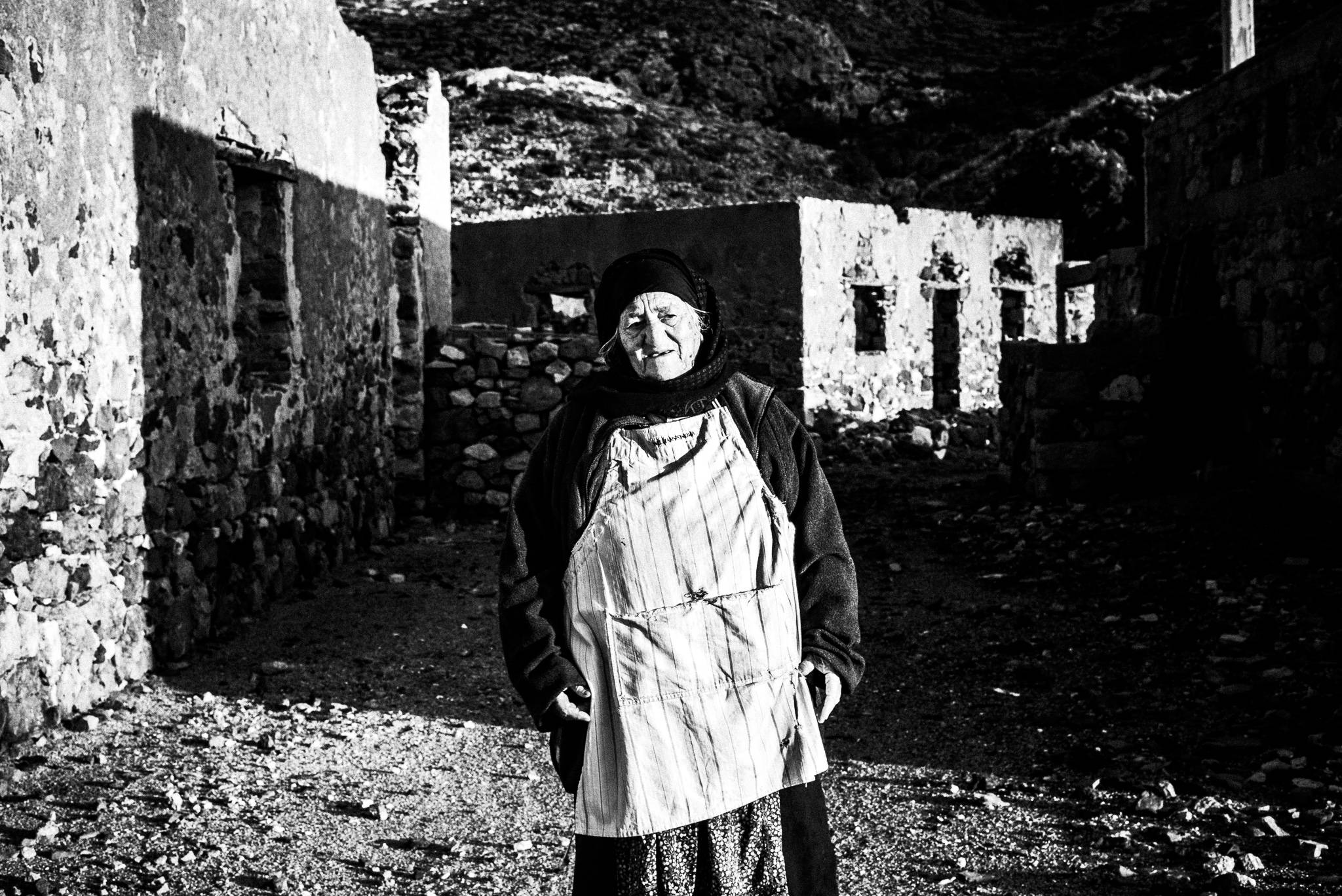 An old lady at the festival of Michael the Archangel at Tristomo, Olympos, Karpathos, Greece. Black and white photography by George Tatakis