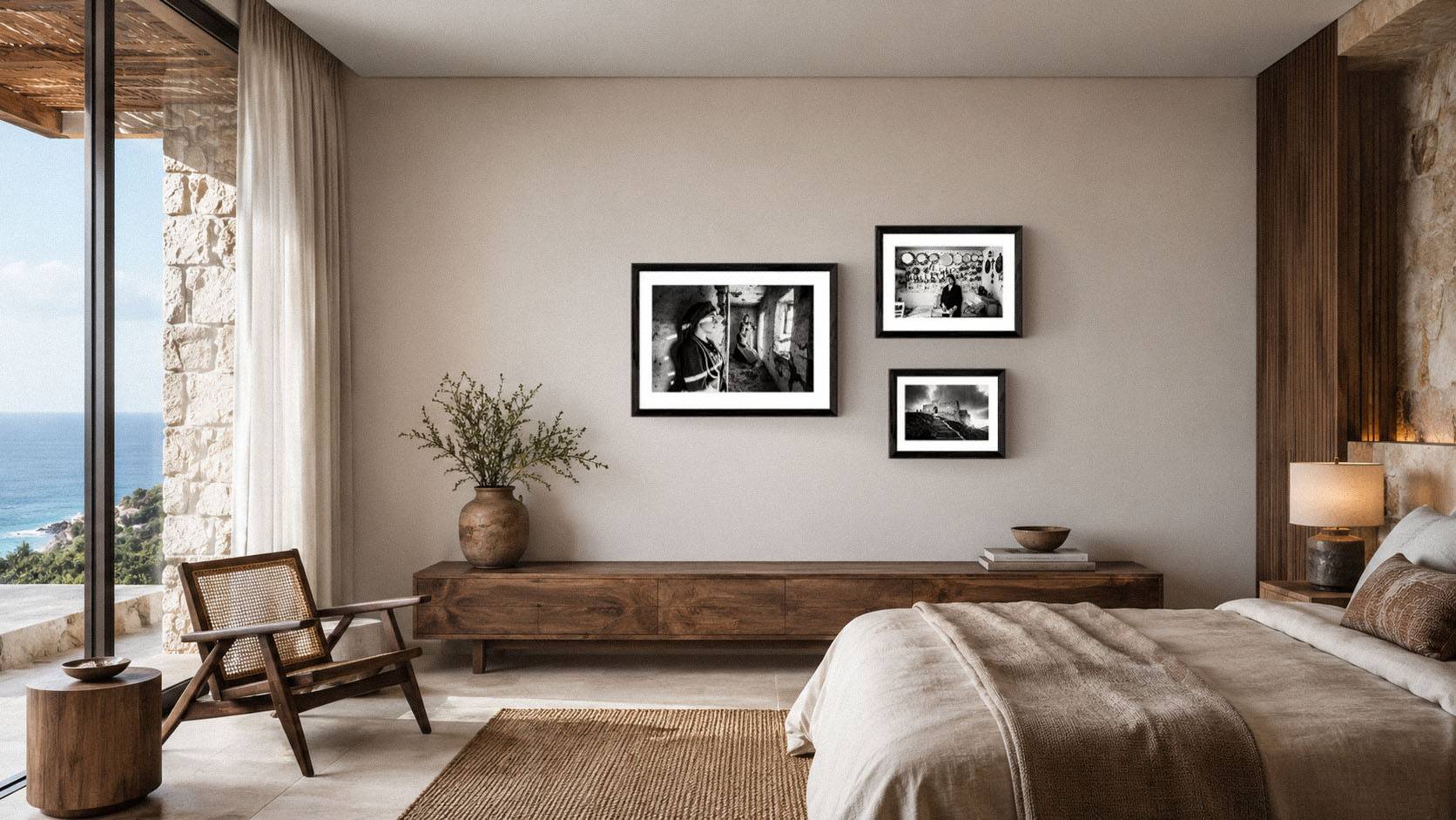 Collection of black-and-white fine-art photographs displayed in a refined bedroom interior, showing how collectors can begin with different formats and sizes.