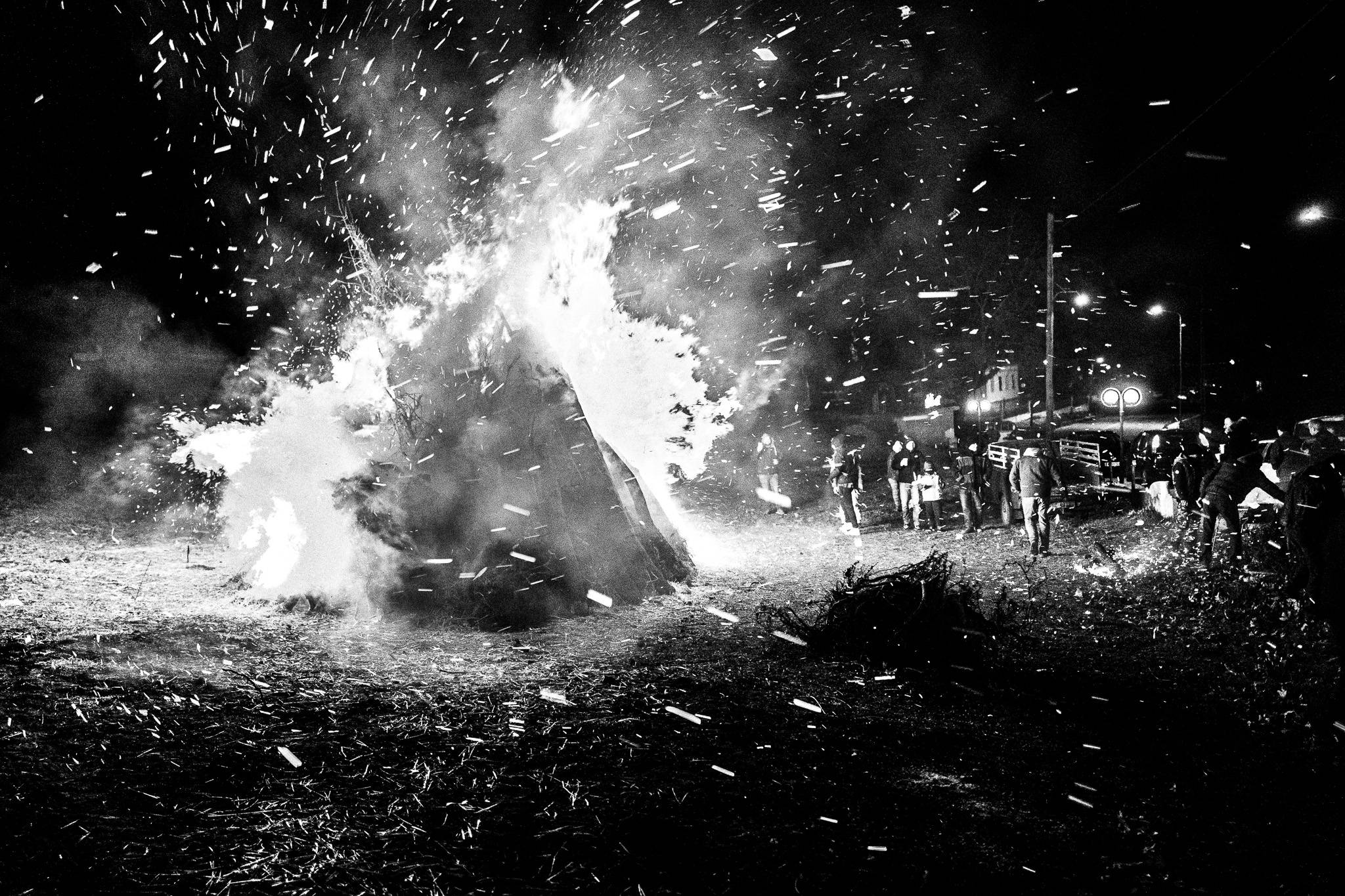 Warming up around the bonfire at Sotira, Pagan Christmas customs of Northern Greece, by photographer George Tatakis