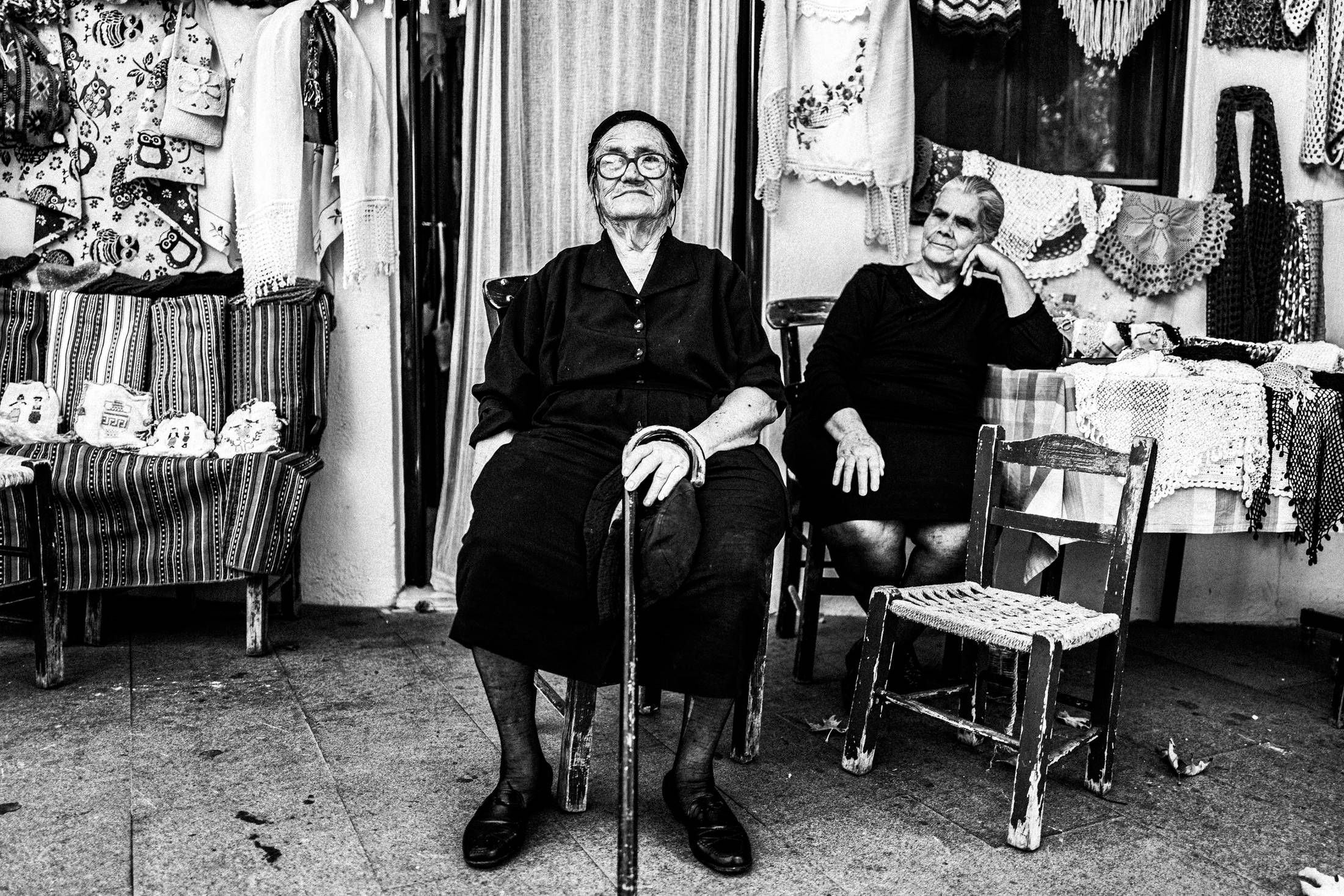 Two friends at a local shop in Anogia, Rethymnon, Crete, by photographer George Tatakis