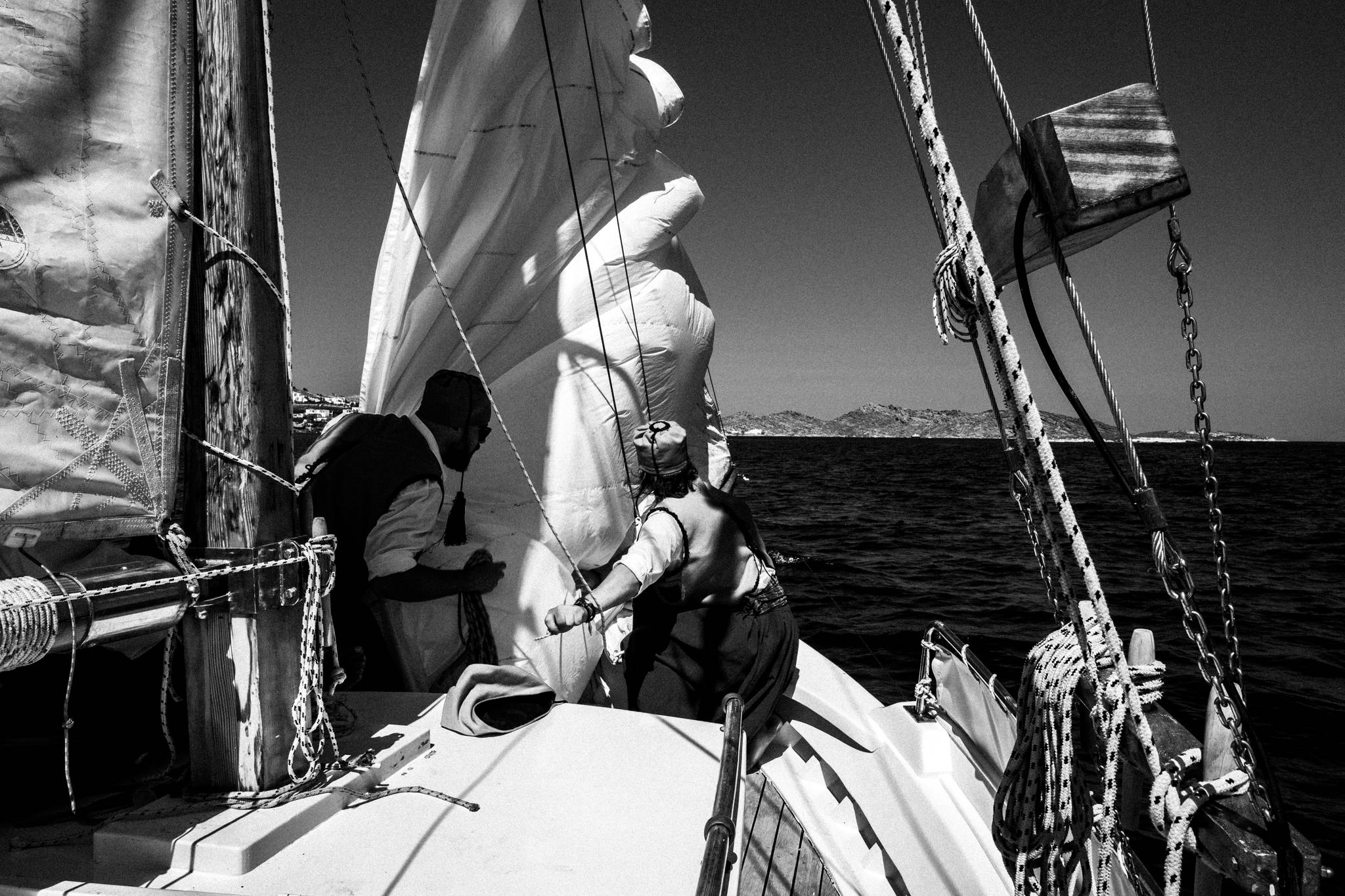 Taking down the sails on board Aghios Georgios, by photographer George Tatakis