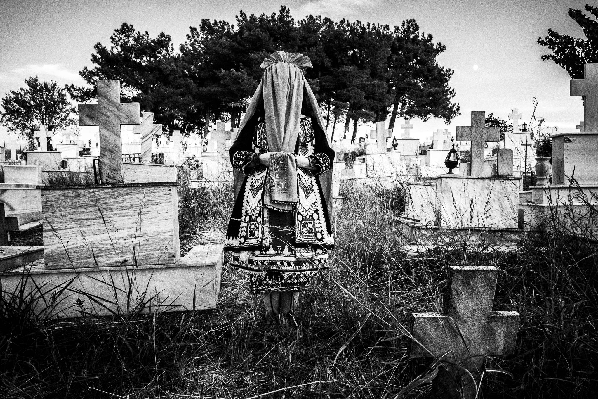 The bride at the local cemetery at Issaakion village, Evros, Thrace, Greece, by photographer George Tatakis