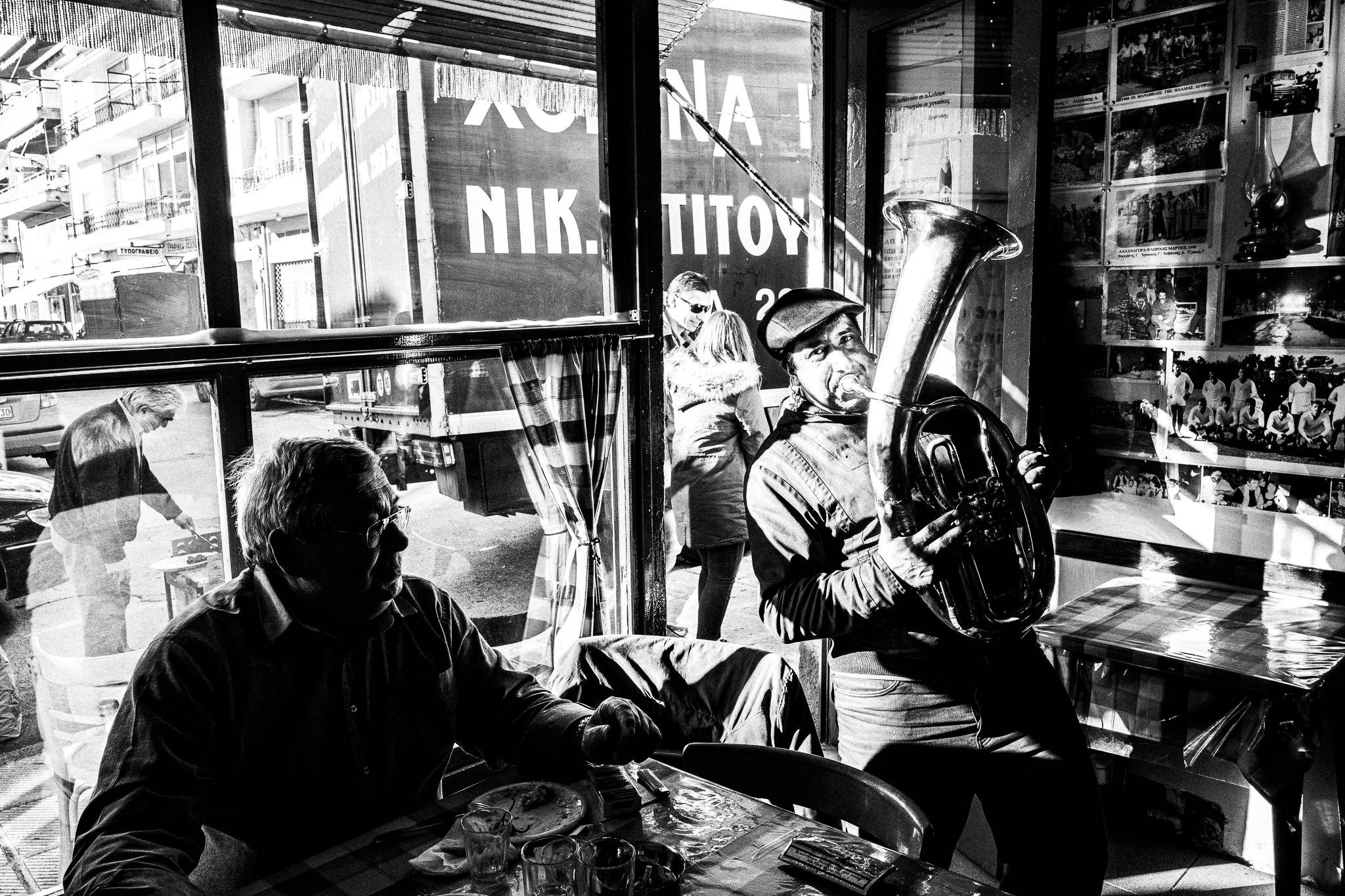 Musicians playing Balkan beats inside a café in Florina, Pagan Christmas customs of Northern Greece, by photographer George Tatakis
