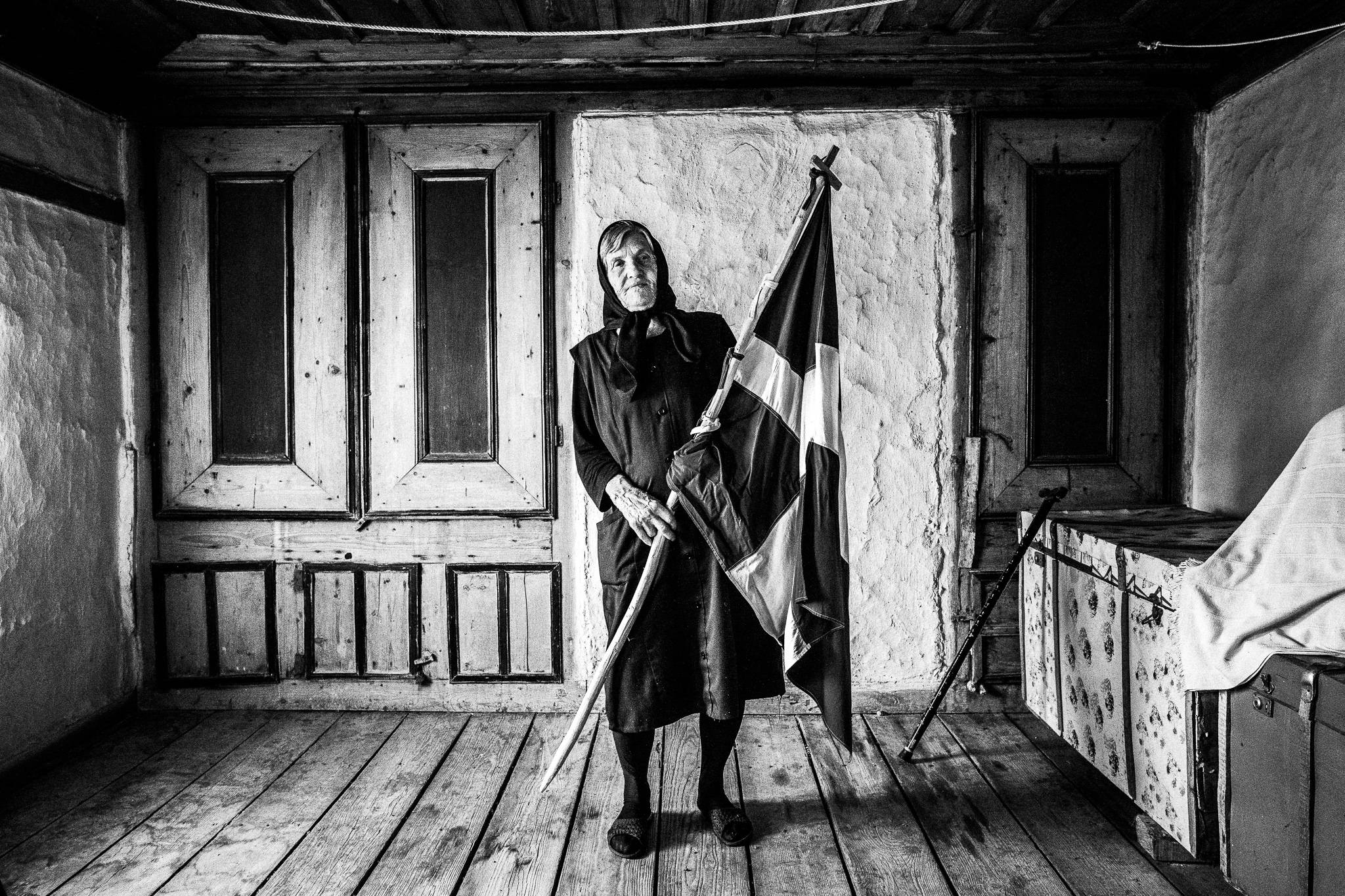 Mrs. Chrisso Passiloudis inside her house with a Greek flag in Metaxades, Evros, Thrace, Greece