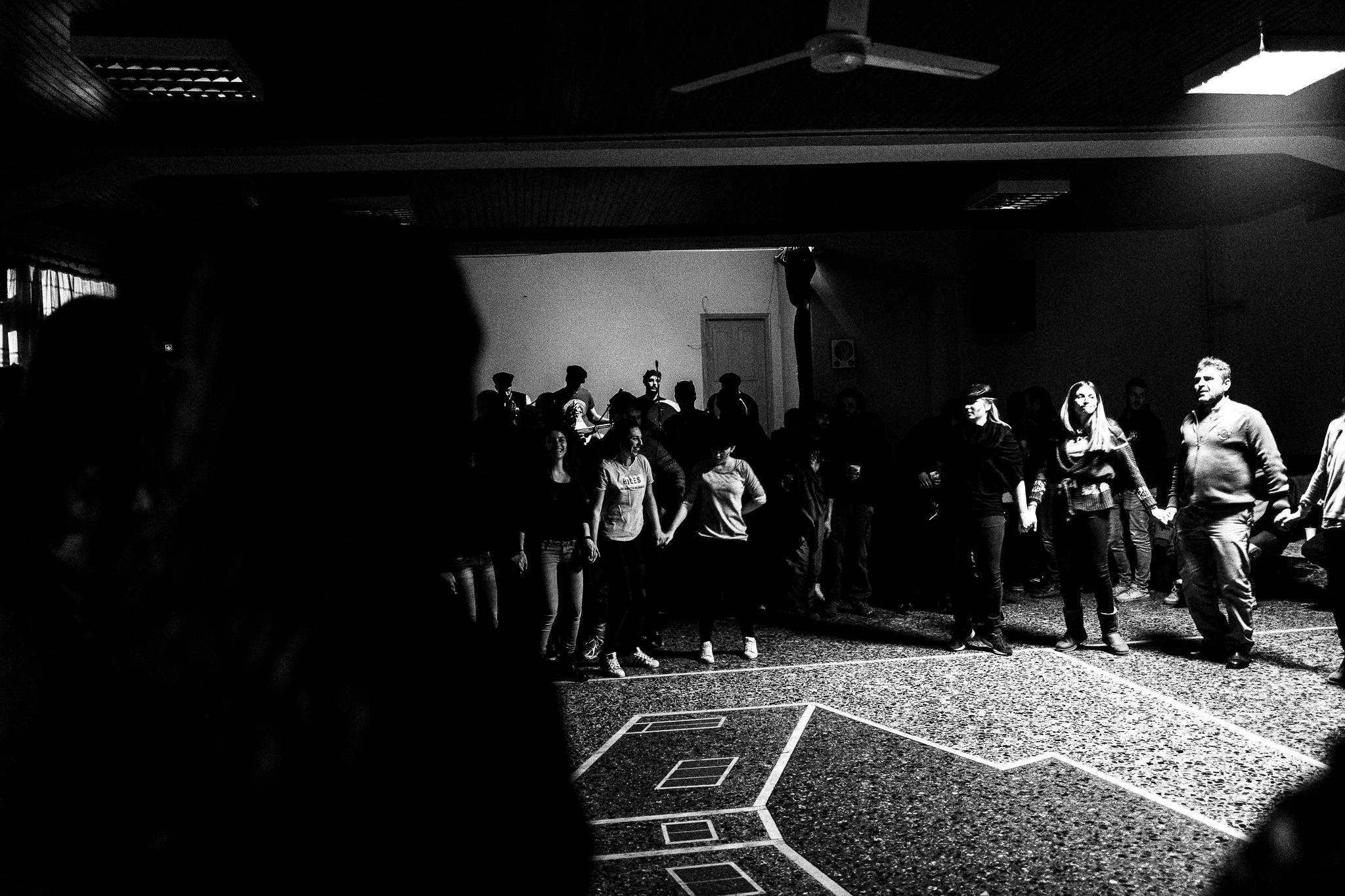 Dancing to local traditional music inside the cultural club, Pagan Christmas customs of Northern Greece, by photographer George Tatakis