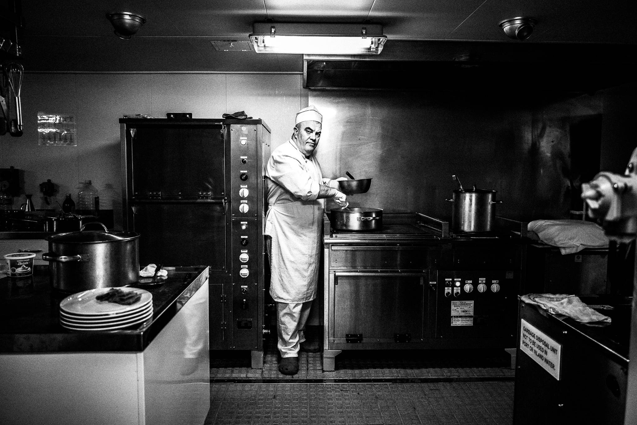 The cook in the galley by photographer George Tatakis
