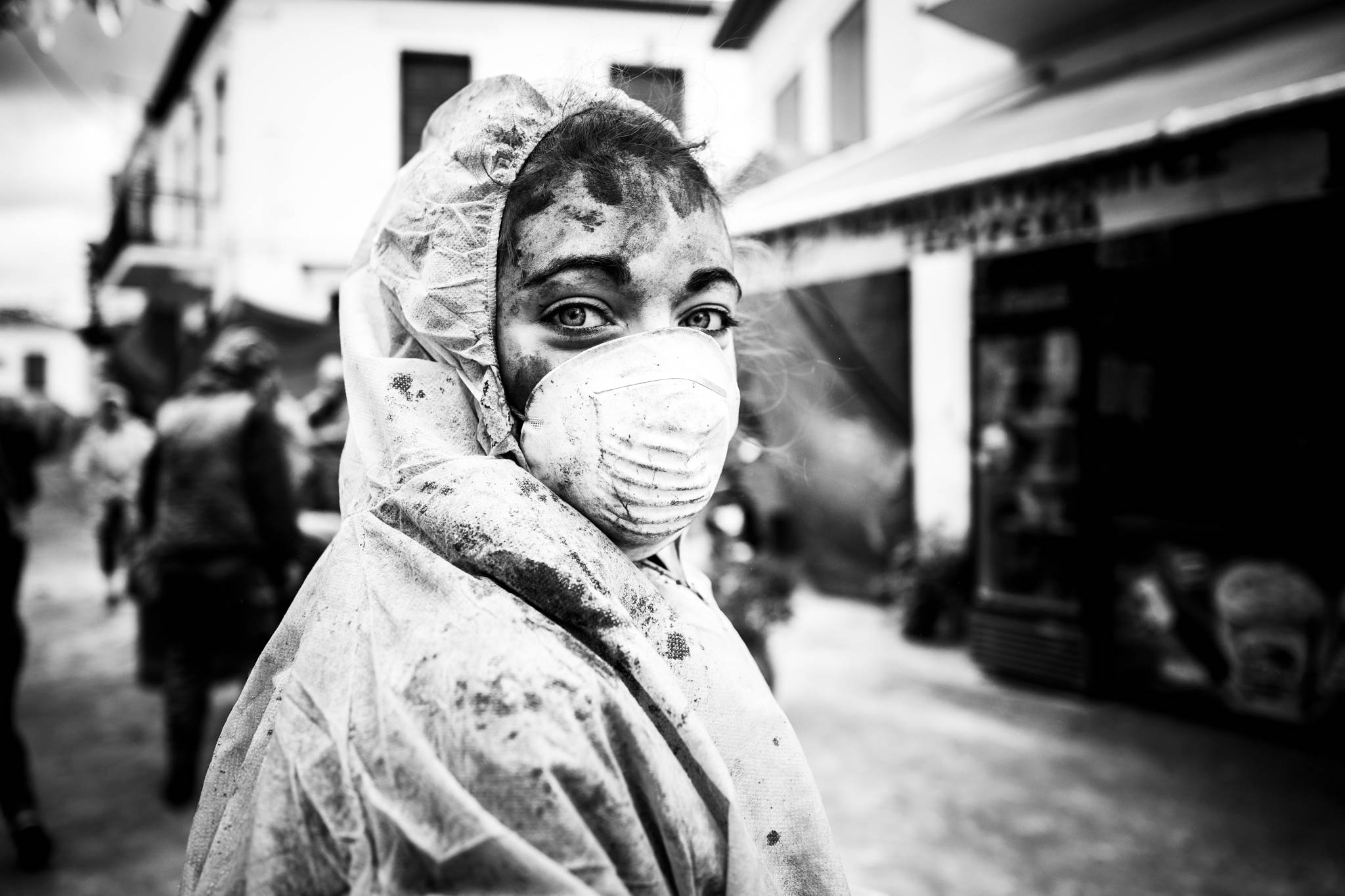 A girl wearing protective face mask and clothes at the flour wars of Galaxidi