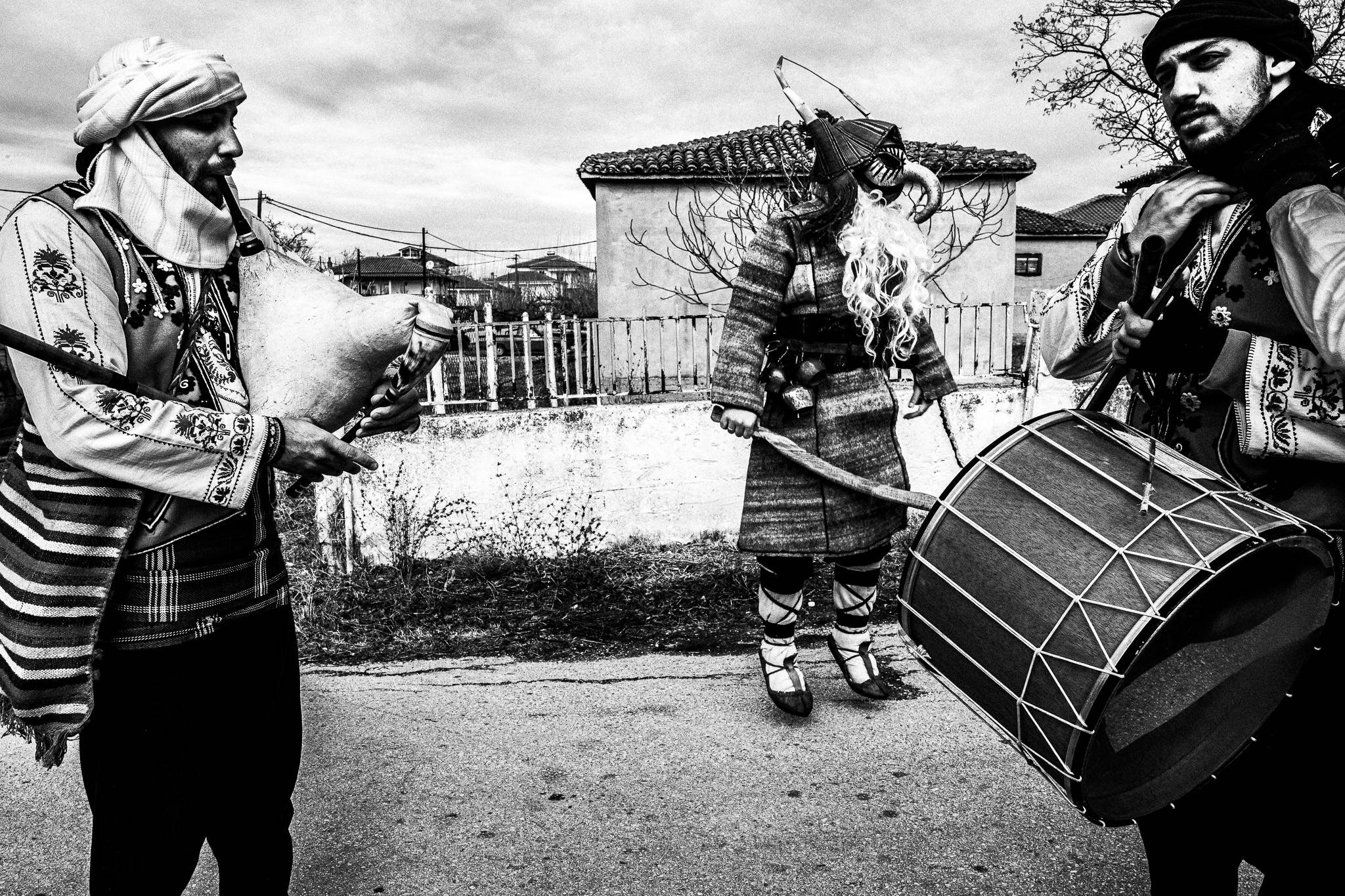 Purpuris with musicians, Pagan Christmas customs of Northern Greece, by photographer George Tatakis