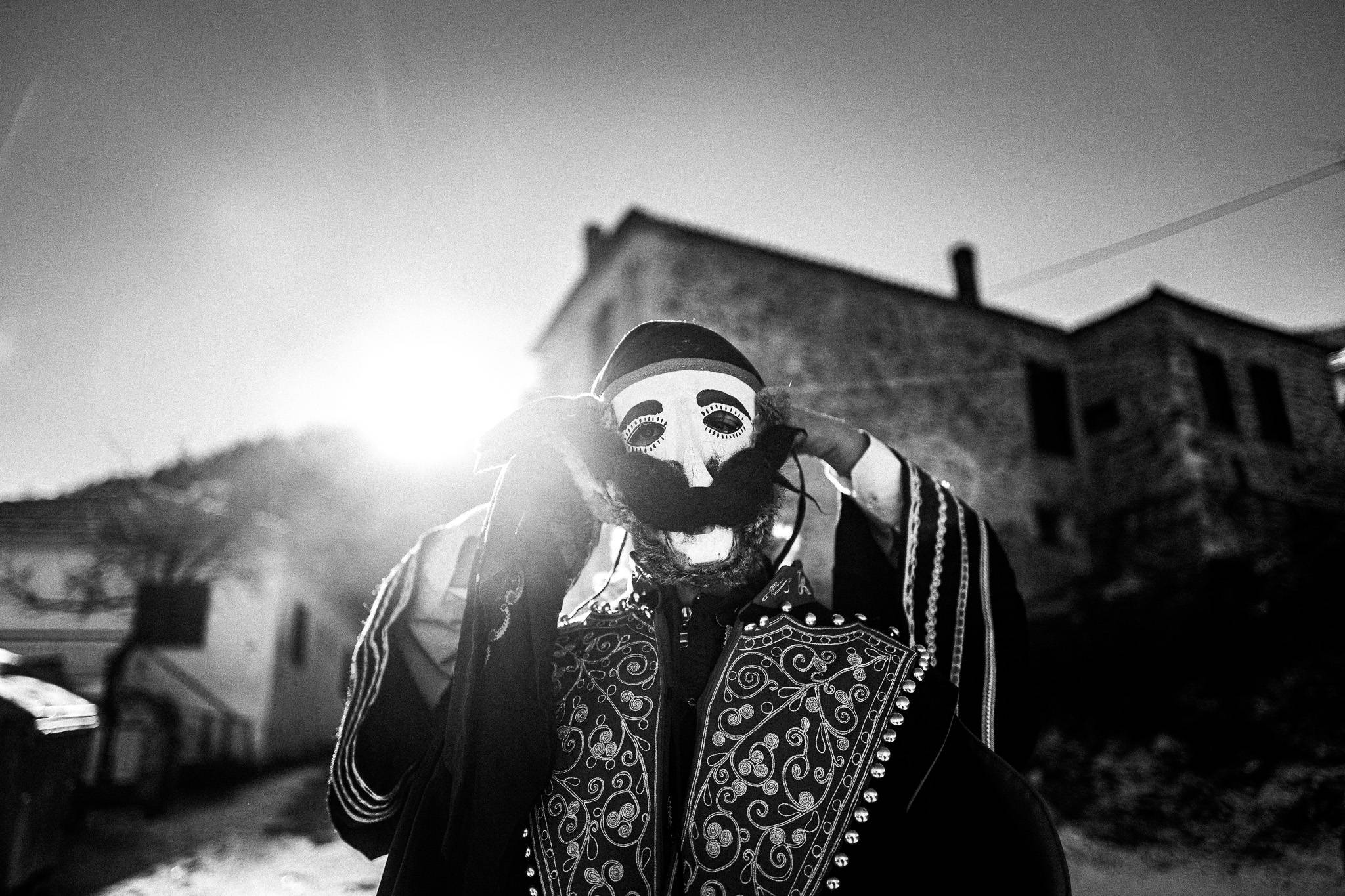 Helping each other wear the mask, Pagan Christmas customs of Northern Greece, by photographer George Tatakis