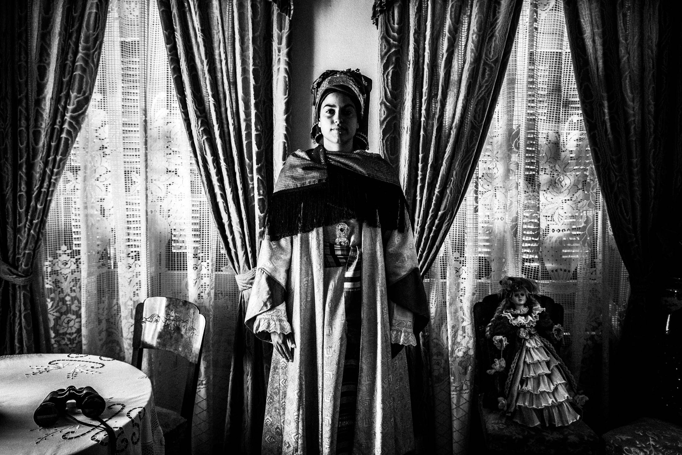 Inside a local traditional house in Symi wearing the traditional costumes, by photographer George Tatakis