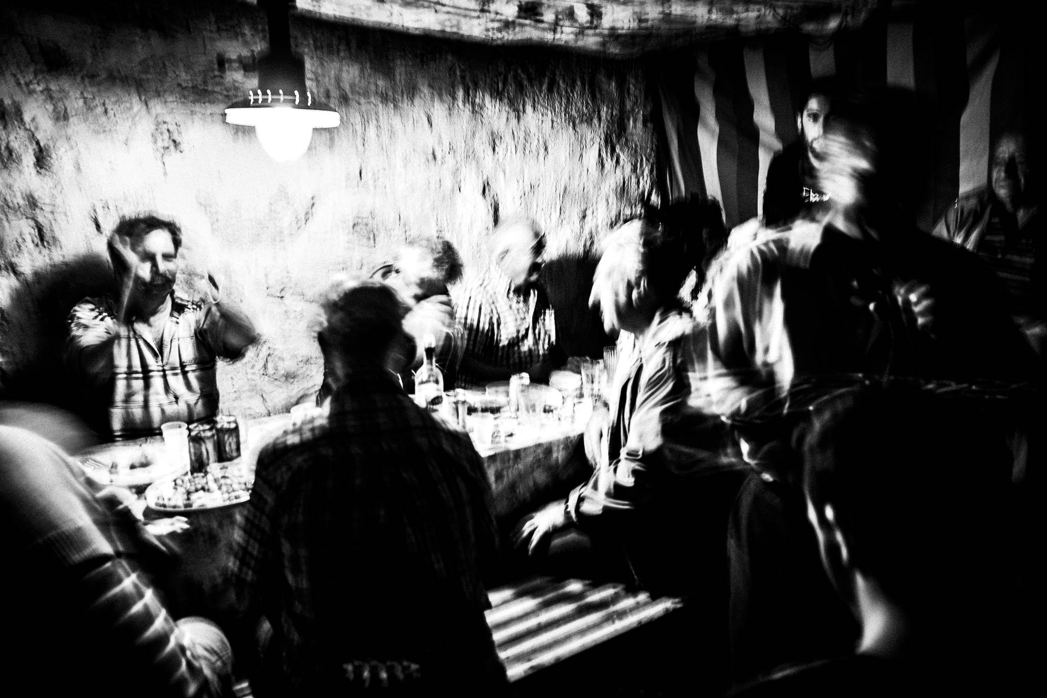 Singing Mantinades during the festival of St. Zacharias at Argos on the island of Saria, Olympos, Karpathos, Greece. Black and white photography by George Tatakis