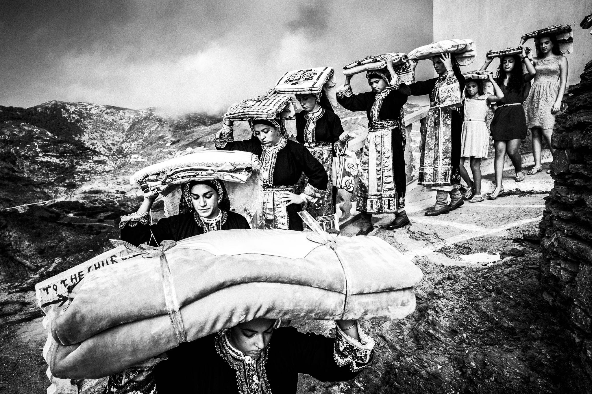 Transporting the groom's dowry across the village in Olympos, Karpathos, Greece. Black and white photography by George Tatakis