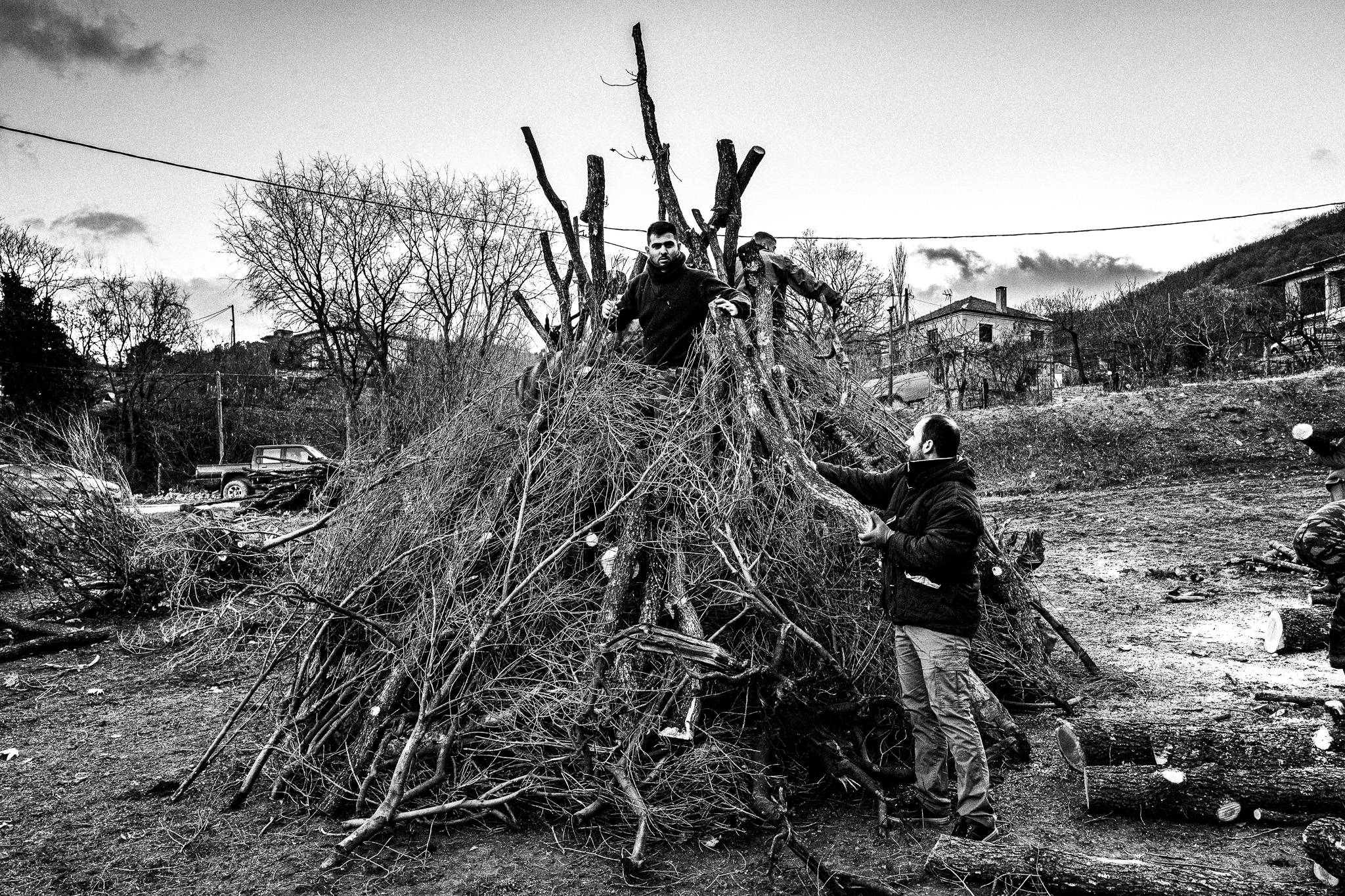 Building up the pile of woods, Pagan Christmas customs of Northern Greece, by photographer George Tatakis