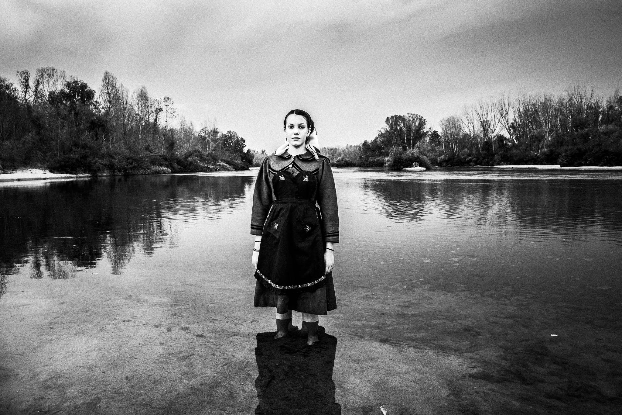 A girl inside Ardas river ini Kastanies, wearing the traditional costume of Nea Vyssa of Evros, Thrace, Greece.