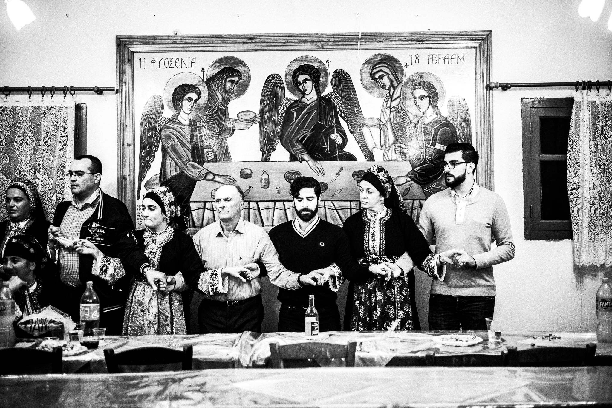 Dancing Pano Choros during the festival of St. Minas, Olympos, Karpathos, Greece. Black and white photography by George Tatakis