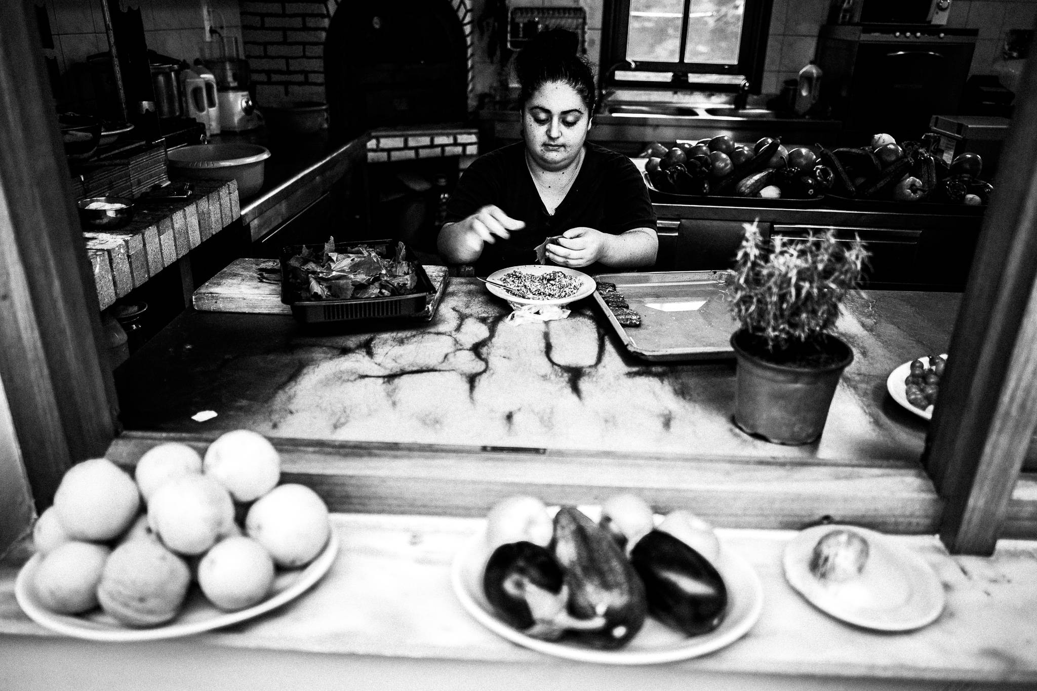 Preparing food at Lendaki's Olympos, Karpathos, Greece. Black and white photography by George Tatakis