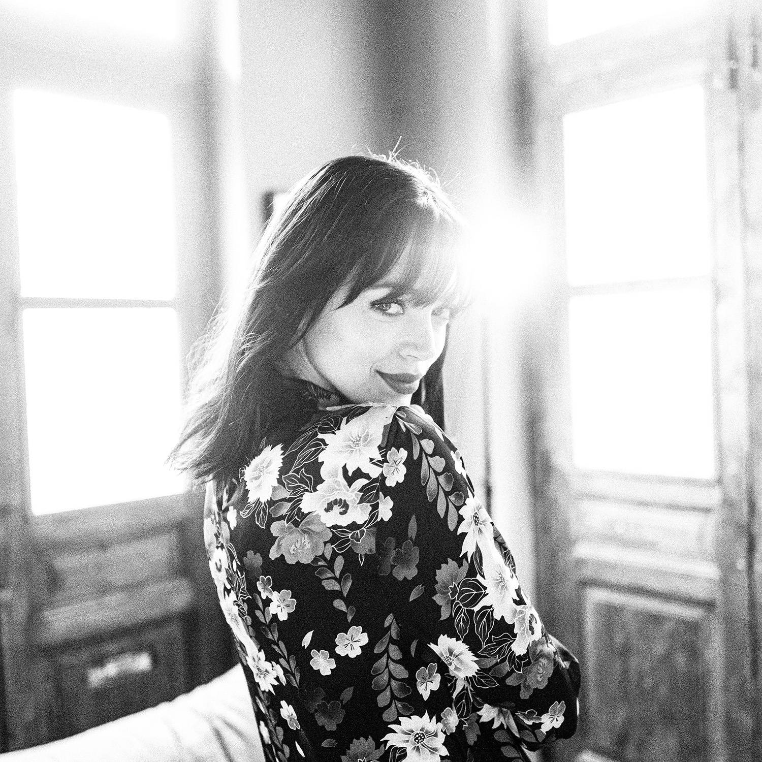 Black and white photograph of a beautiful model posing against sunlight