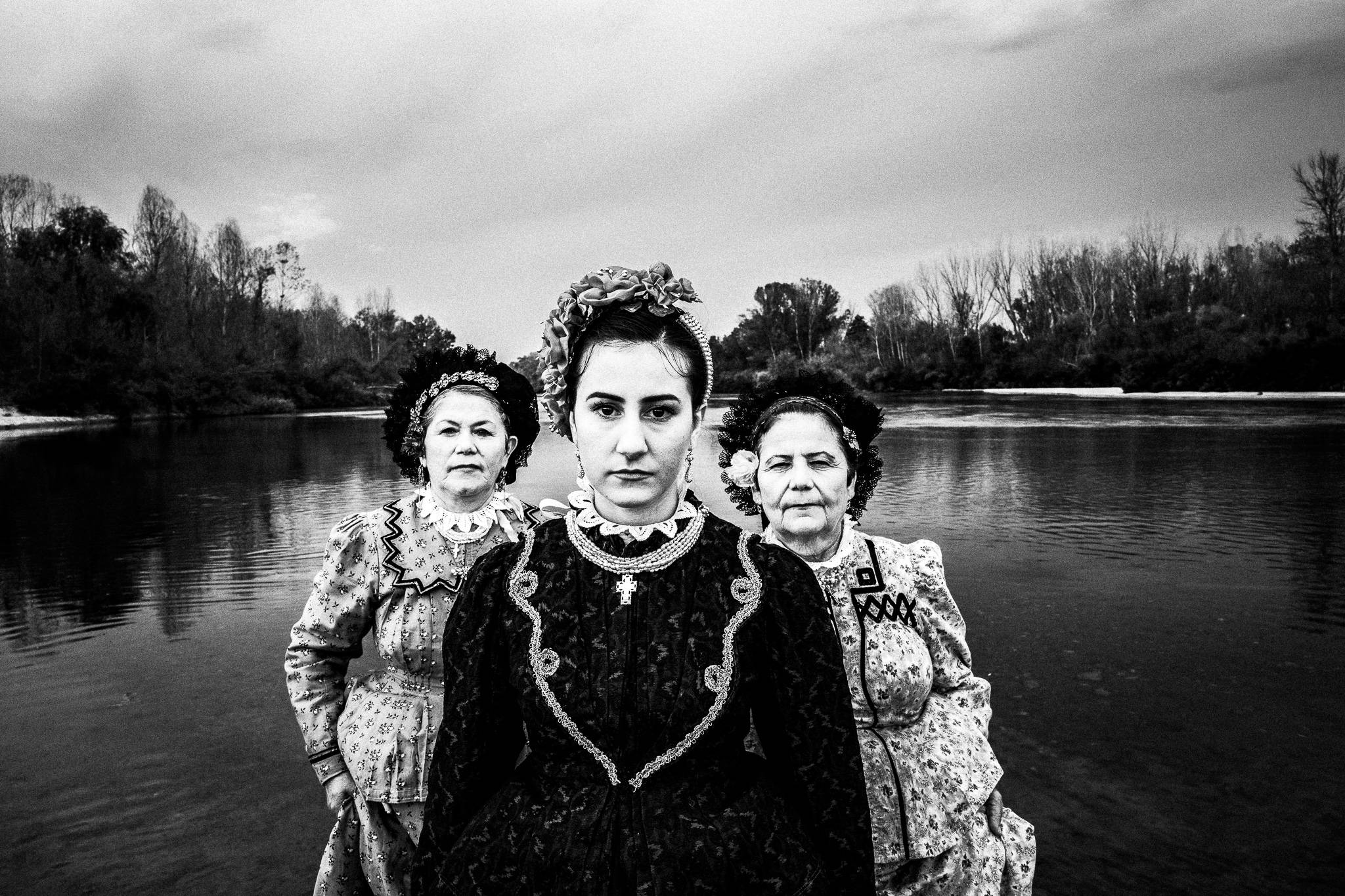 Three ladies in traditional costumes of Nea Vyssa, inside Ardas river, Evros, Thrace, Greece.