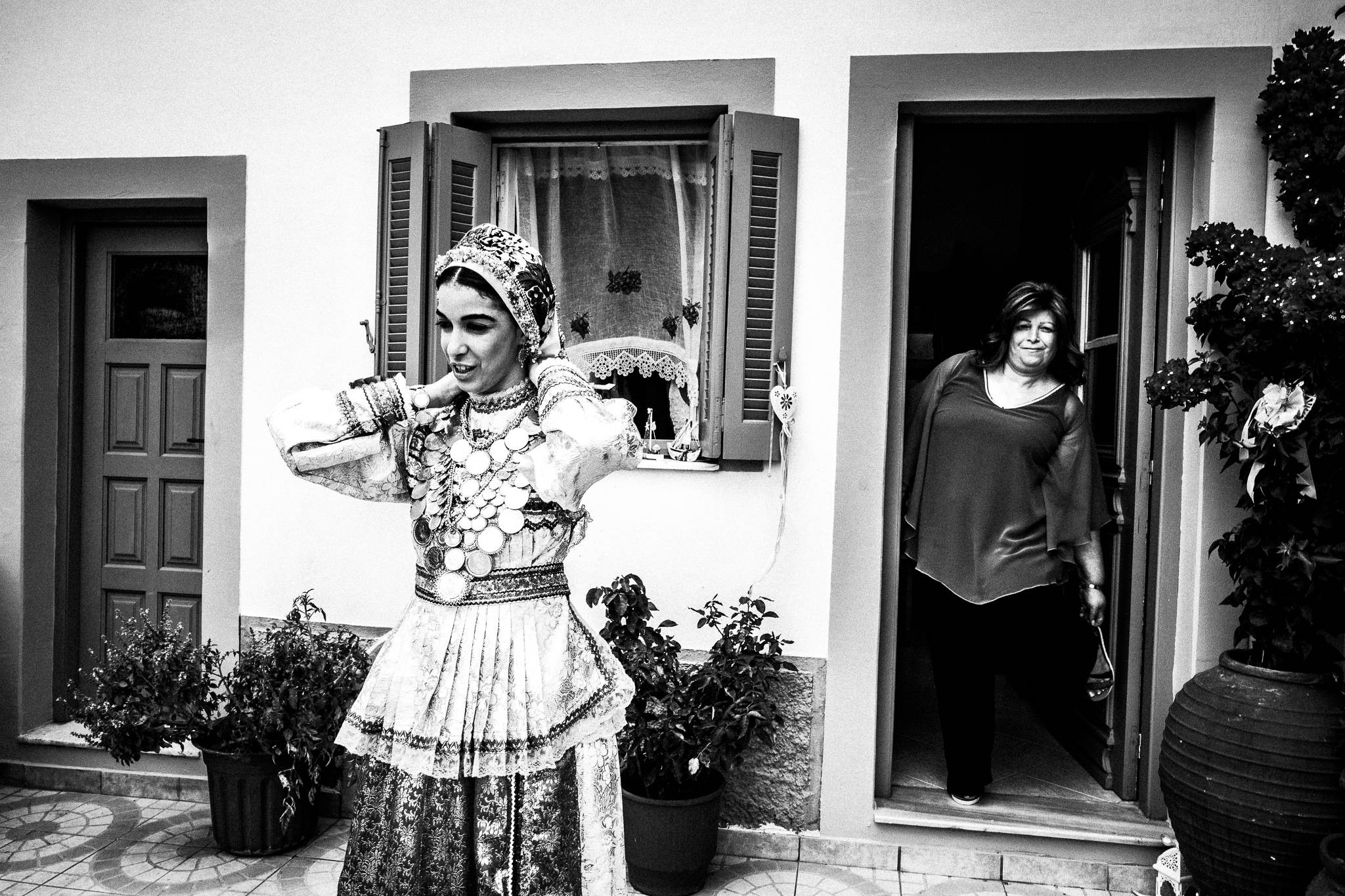 The bride-to-be waits for the groom in Olympos, Karpathos, Greece. Black and white photography by George Tatakis