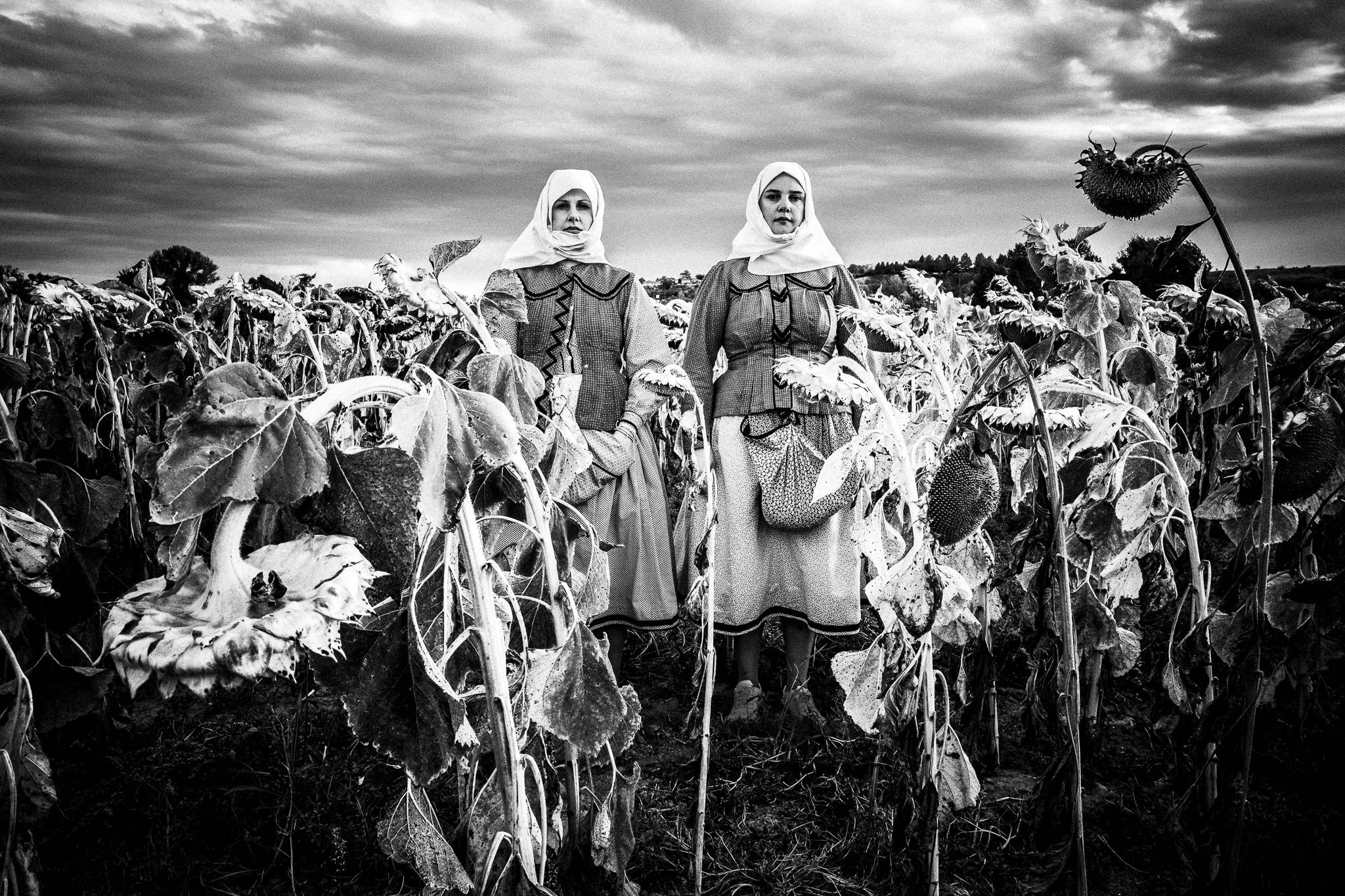 Two sisters amongst sunflowers in Nea Vyssa, Evros, Thrace, Greece, by photographer George Tatakis