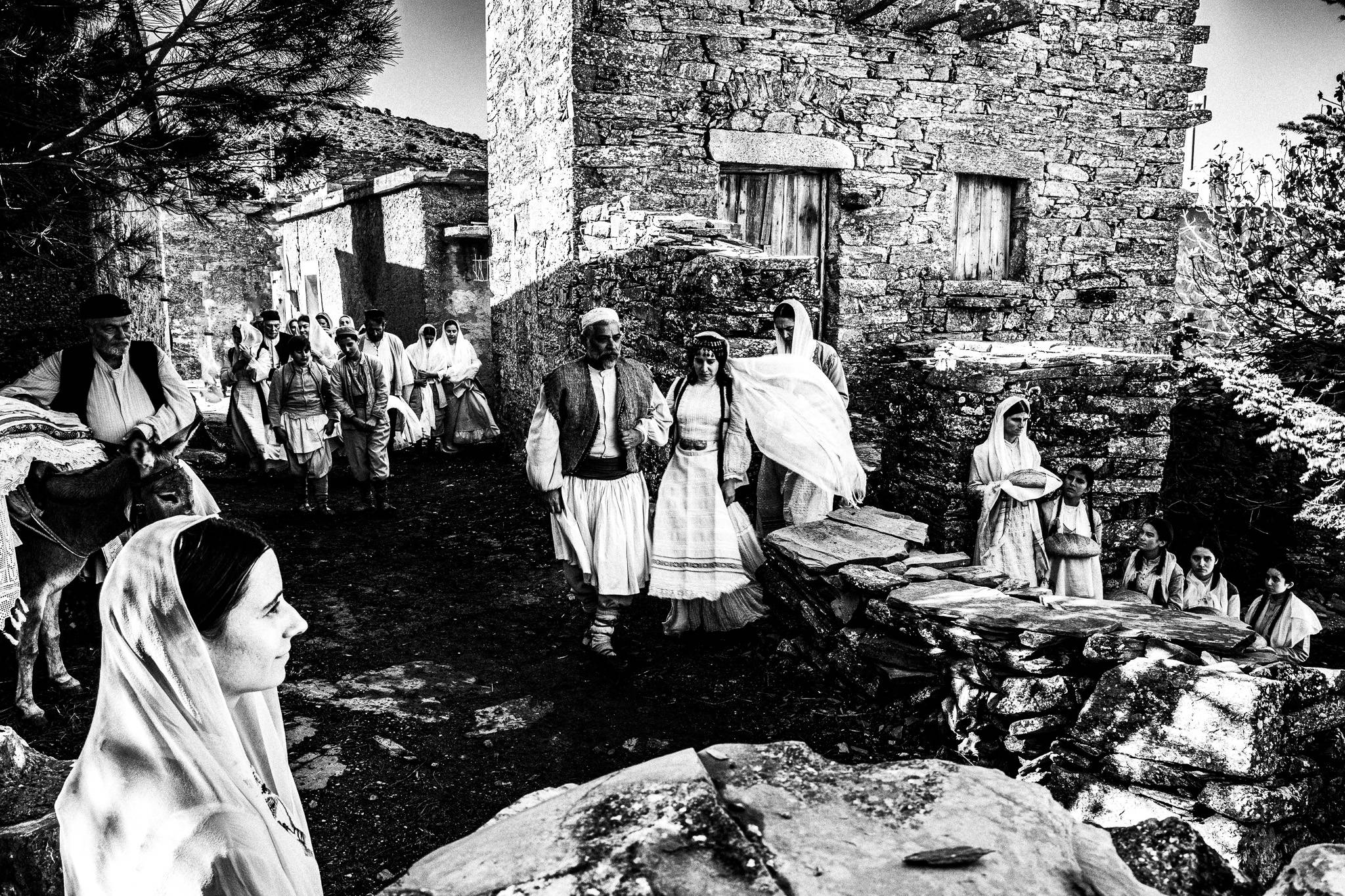 Filming of a scene featuring a local wedding. Black and white photography by George Tatakis during the filming of 'Φόνισσα'(Fonissa).