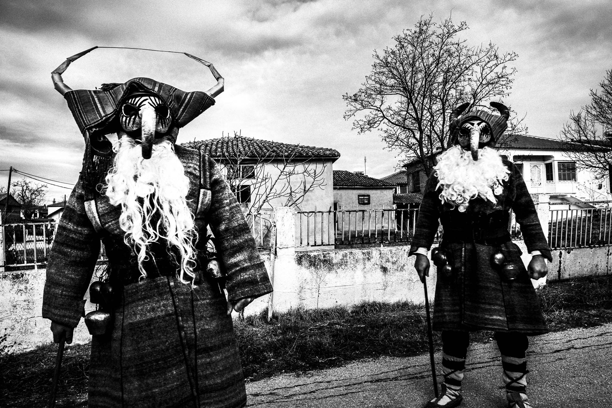 Two men dressed in the Purpuris costume, Pagan Christmas customs of Northern Greece, by photographer George Tatakis