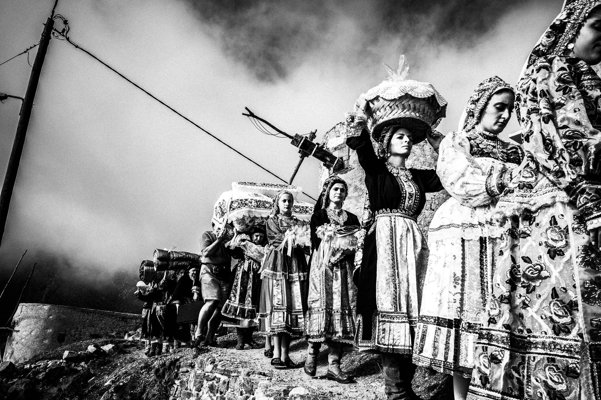 The dowry Carried through the village at a wedding in Olympos, Karpathos, Greece. Black and white photograph by George Tatakis