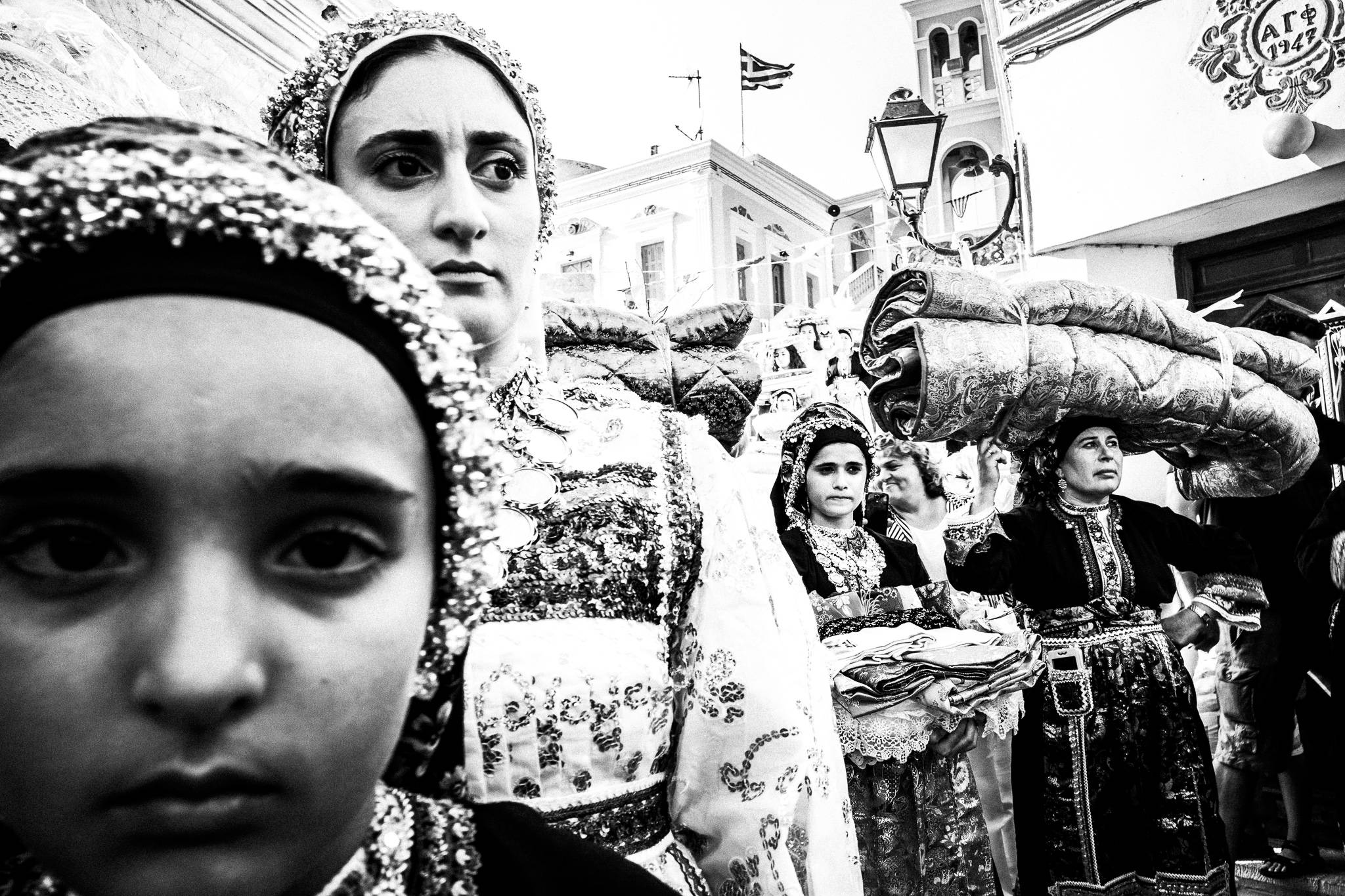 The dowry is having a brief stop in Olympos, Karpathos, by photographer George TatakisThe dowry at a wedding in Olympos, Karpathos, Greece. Black and white photography by George Tatakis
