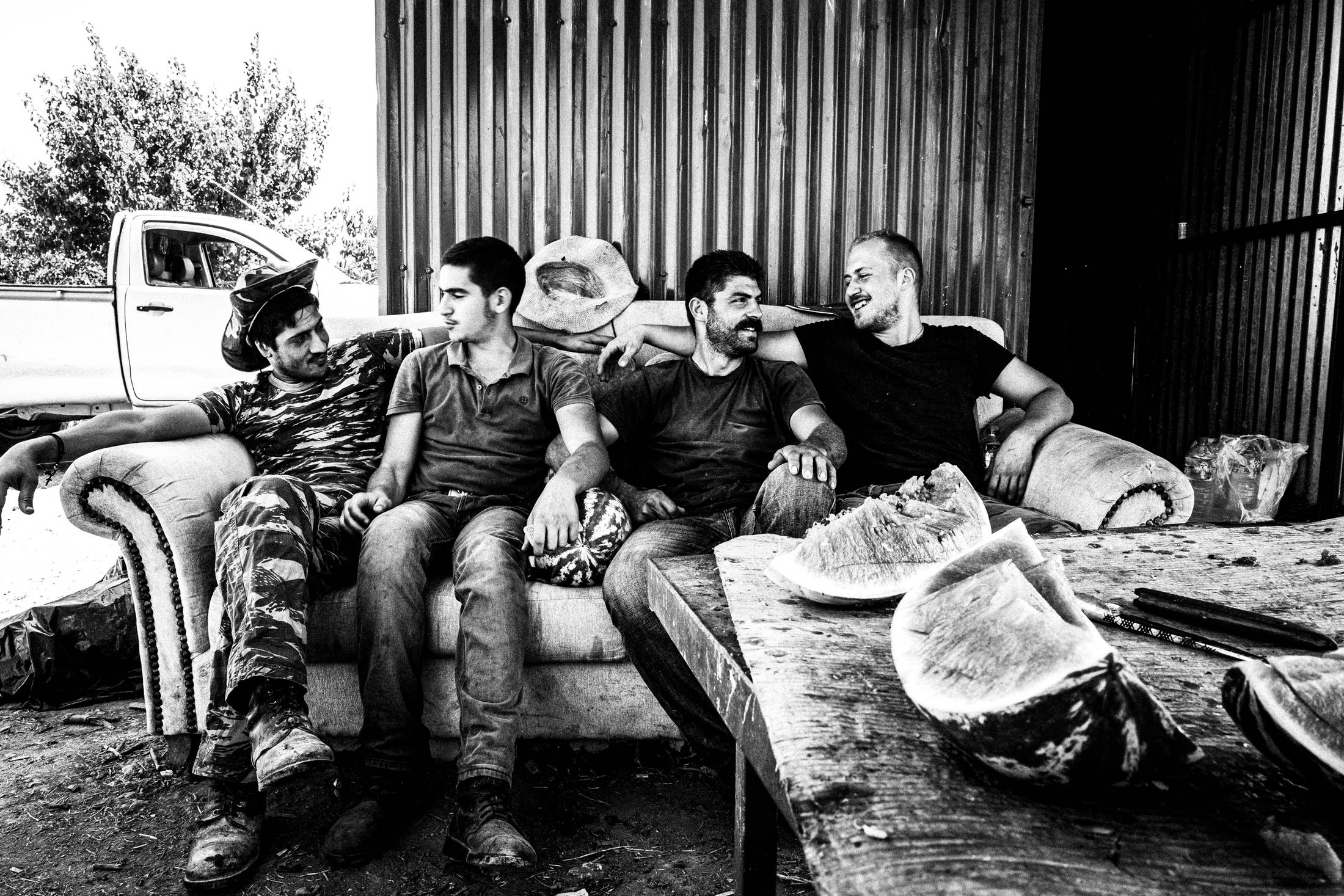 A group of friends at a local pen, Anogia, Rethymnon, Crete, by photographer George Tatakis