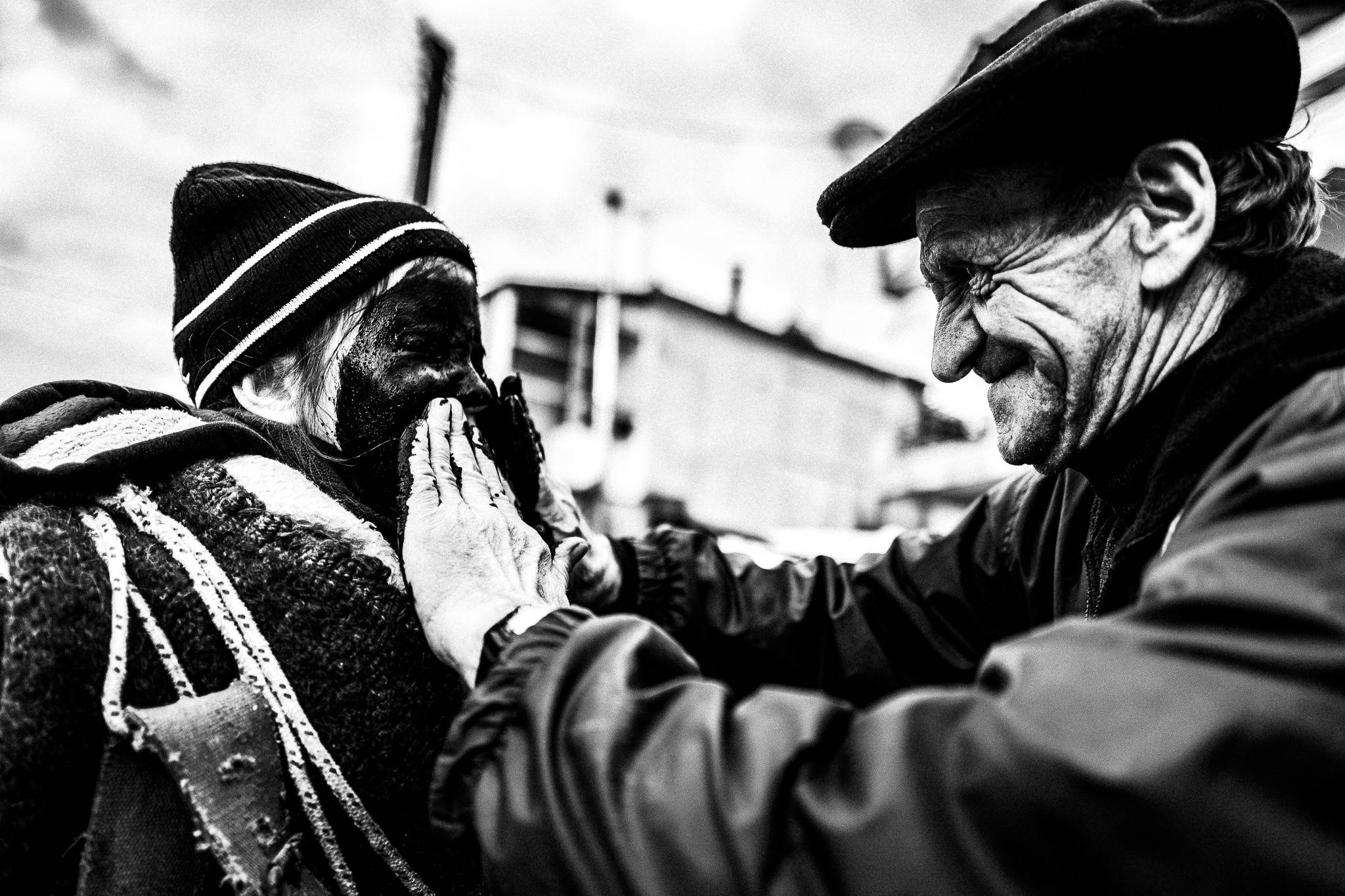 Painting the faces pitch black for a more intimidating result, Pagan Christmas customs of Northern Greece, by photographer George Tatakis