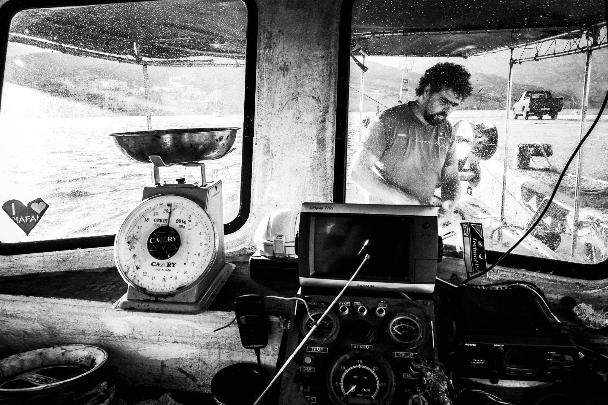 Pavlos preparing the boat, Diafani, Olympos, Karpathos, Greece. Black and white photography by George Tatakis