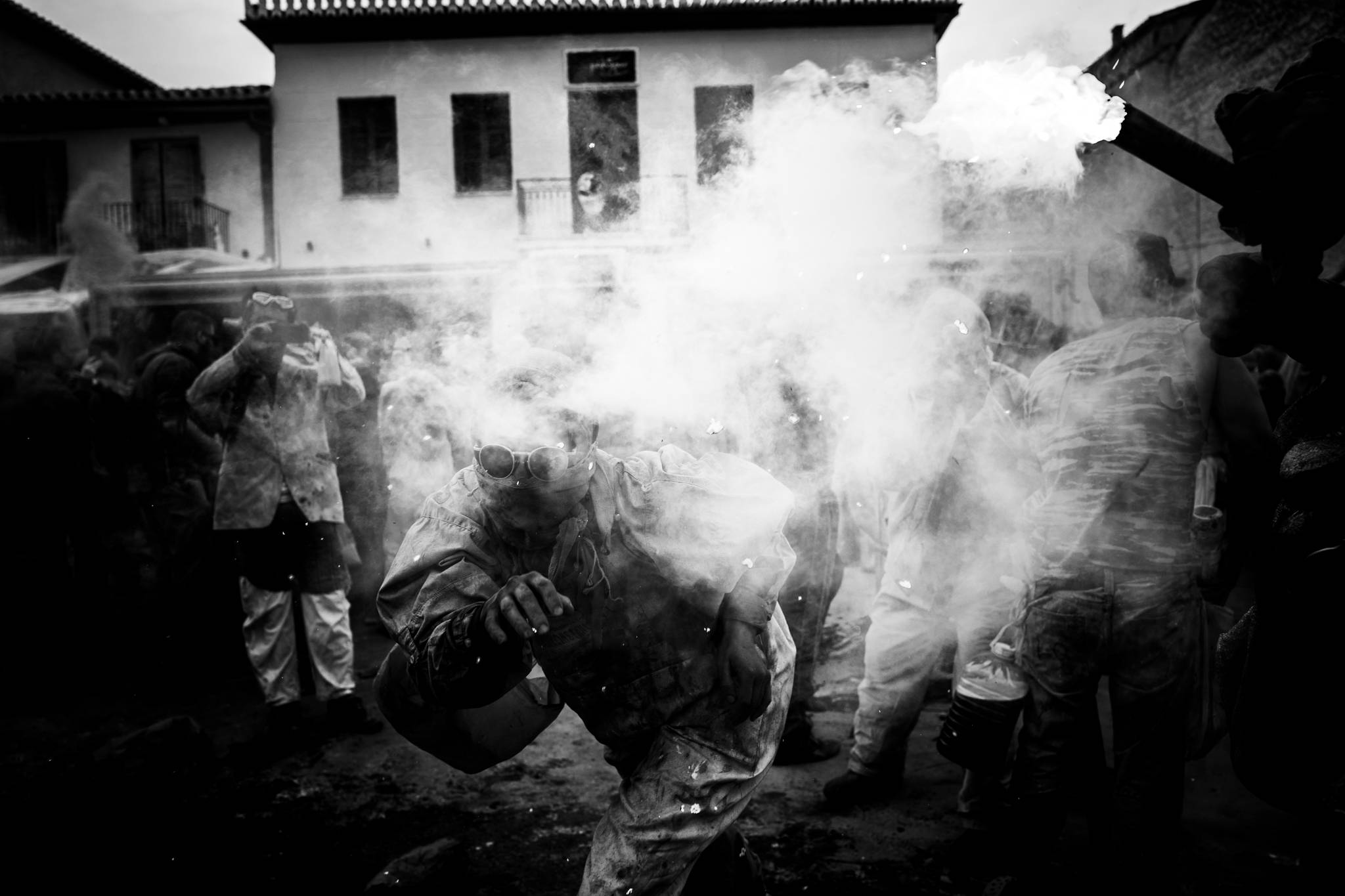 Walking through a smokescreen at the flour wars of Galaxidi, by photographer George Tatakis