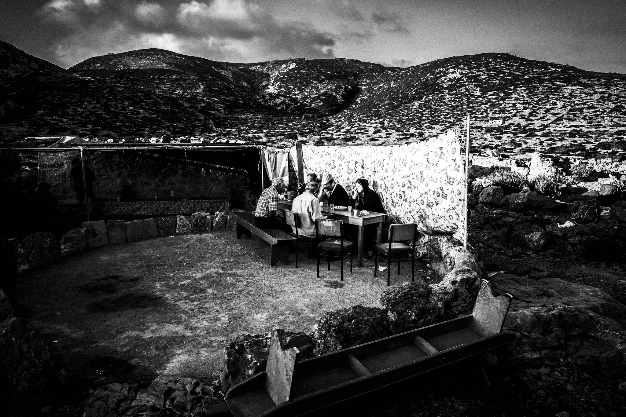 Sun rise with music and singing during the festival of St. Zacharias at Argos on the island of Saria, Olympos, Karpathos, Greece. Black and white photography by George Tatakis