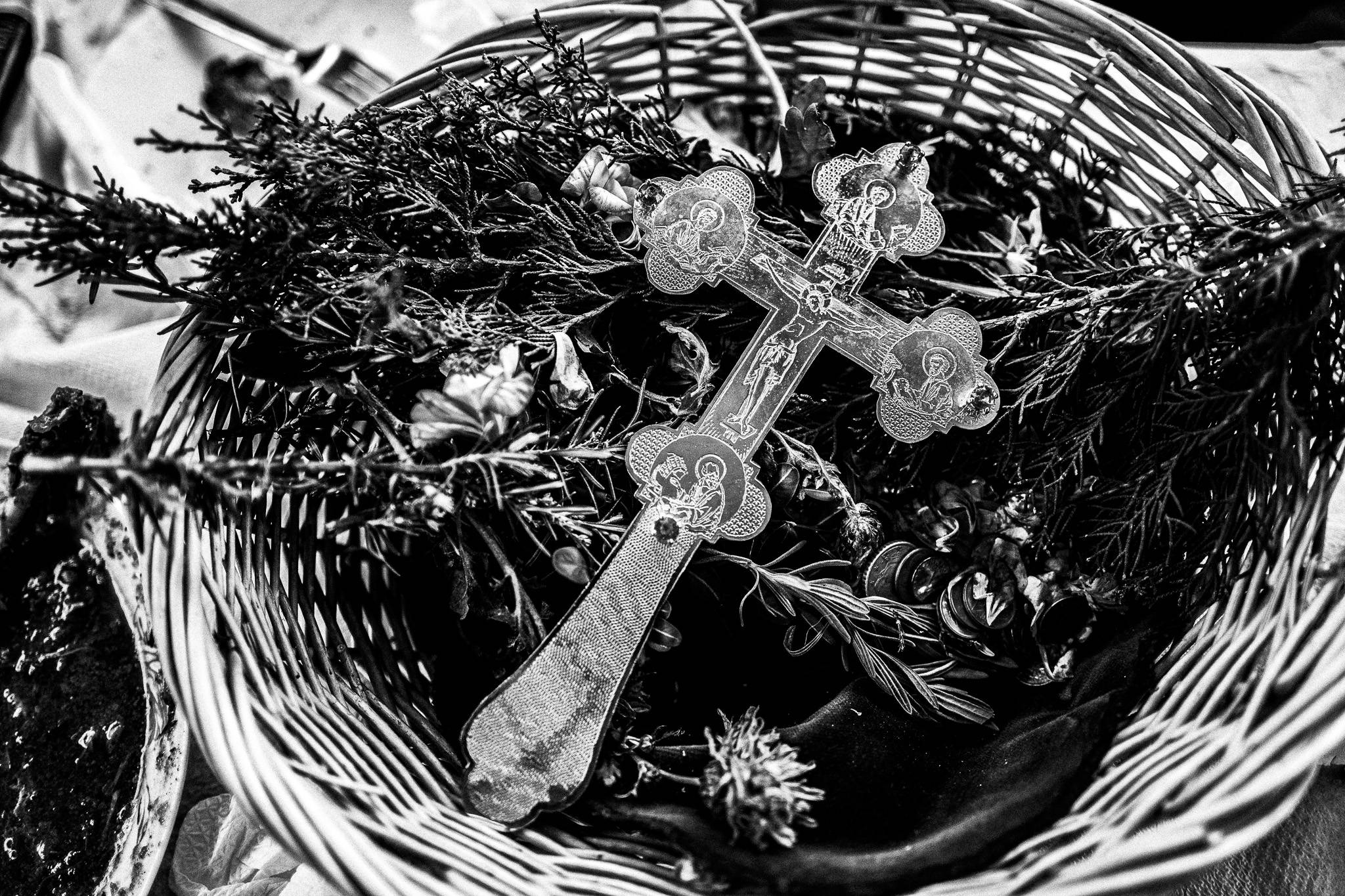 The crucifix that blessed the water during Epiphany, Pagan Christmas customs of Northern Greece, by photographer George Tatakis