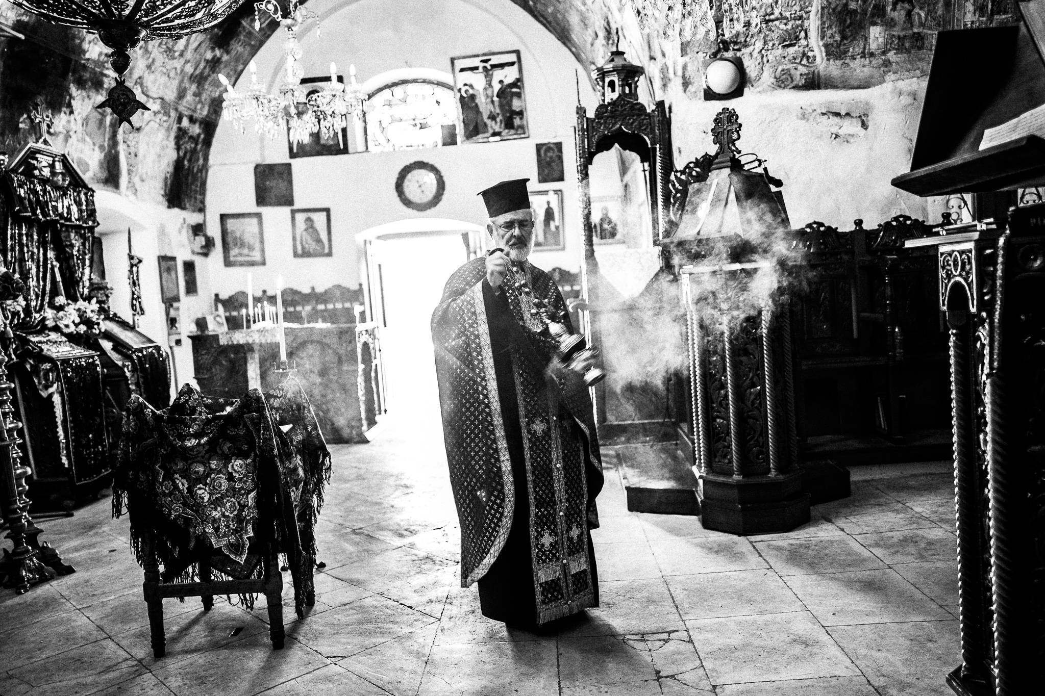 The local priest, performing a liturgy at the main church on Holy Wednesday. Olympos, Karpathos, Greece