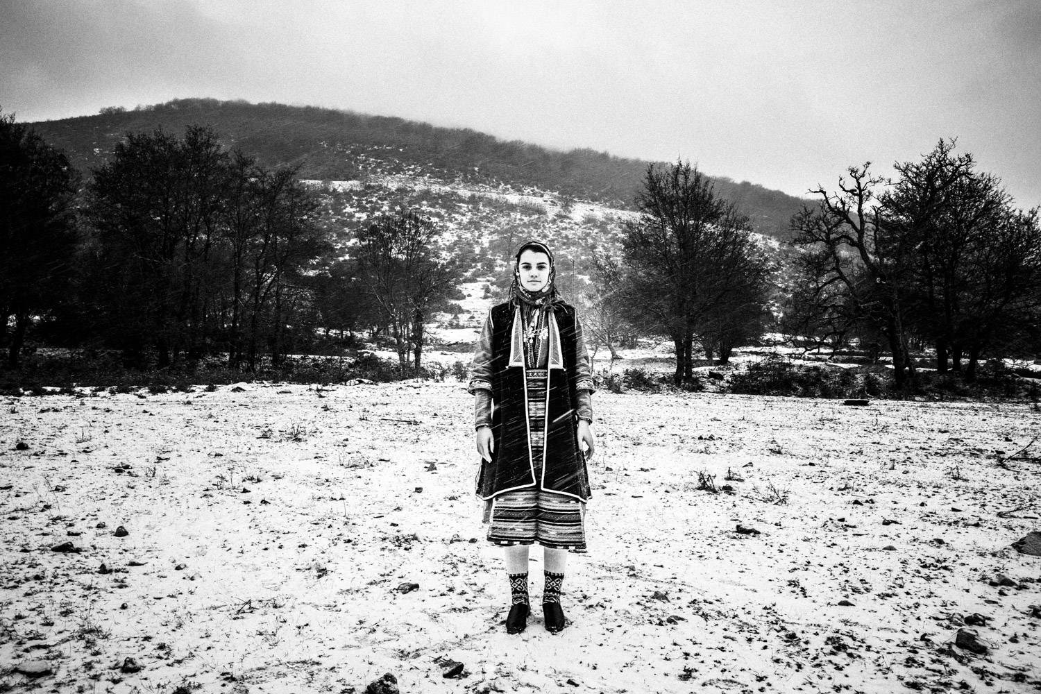 A woman in the snow in Volax, Drama, Macedonia, Greece. Black and white photograph by George Tatakis
