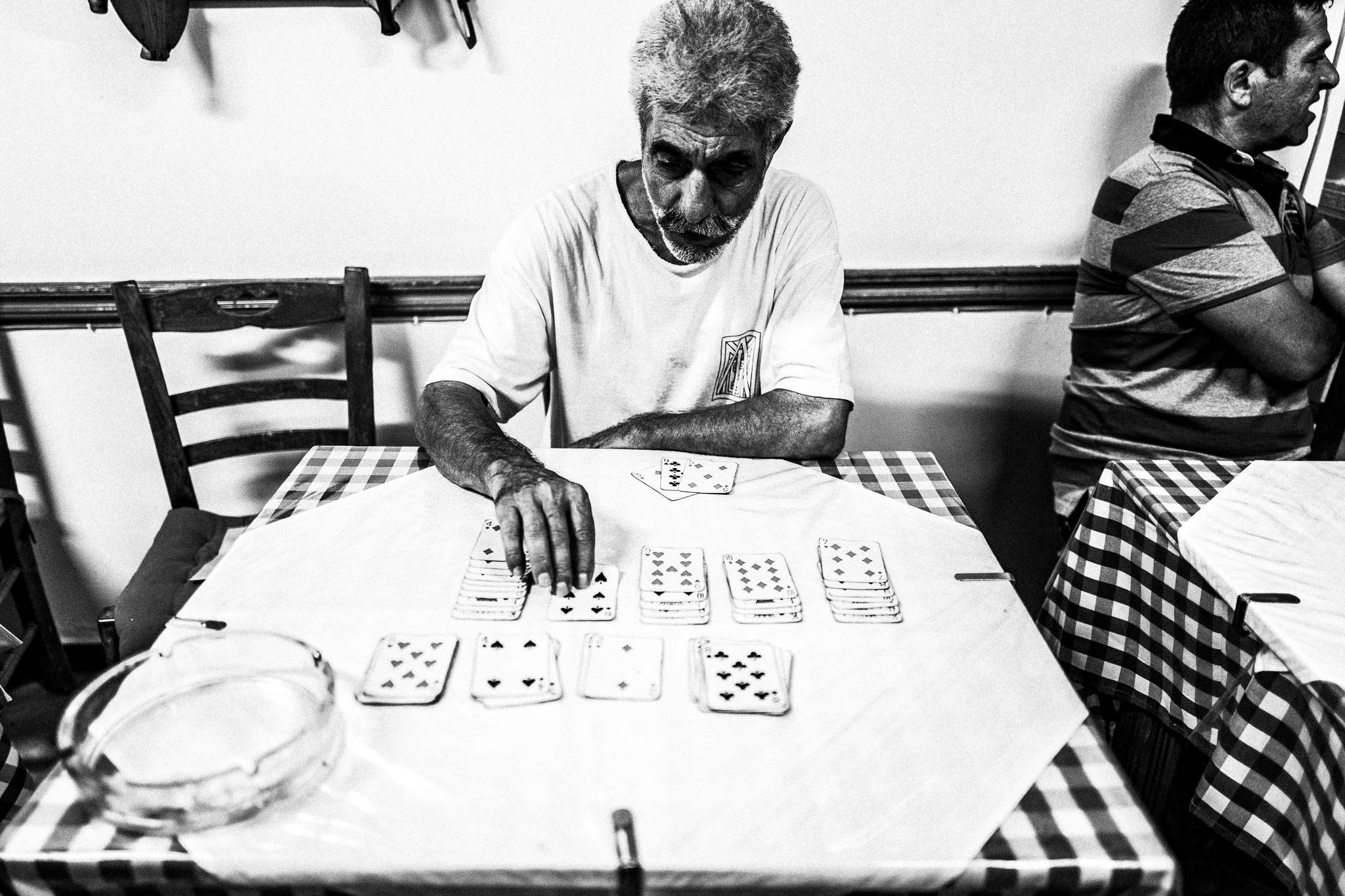 Solitaire at Parthenon in Olympos, Karpathos, Greece. Black and white photography by George Tatakis