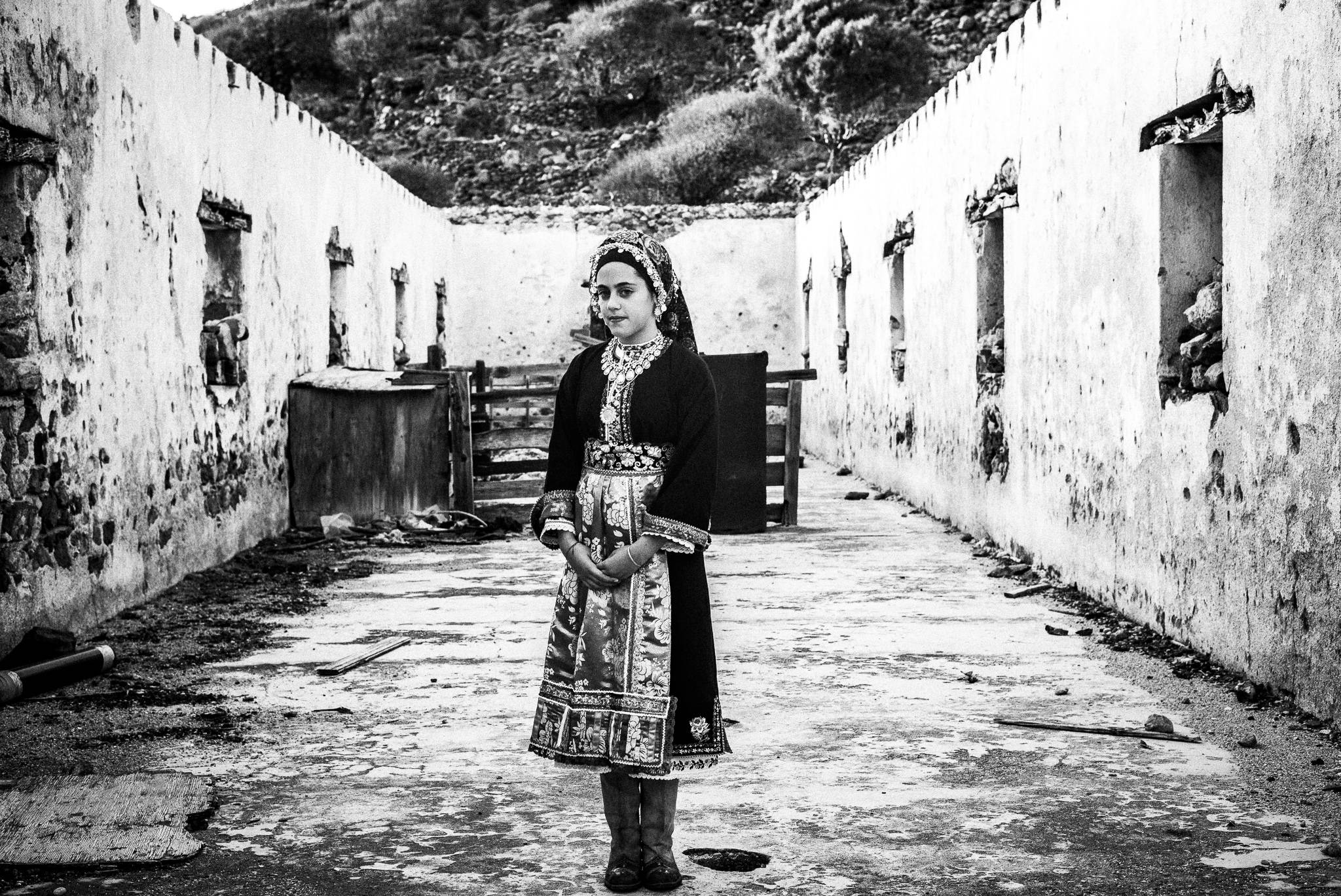 Girl in the traditional kava'e at the festival of Michael the Archangel at Tristomo, Olympos, Karpathos, Greece. Black and white photography by George Tatakis