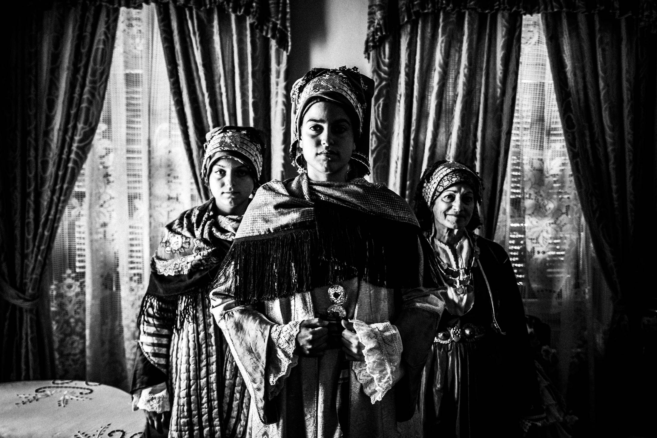 Inside a local traditional house in Symi wearing the traditional costumes, by photographer George Tatakis