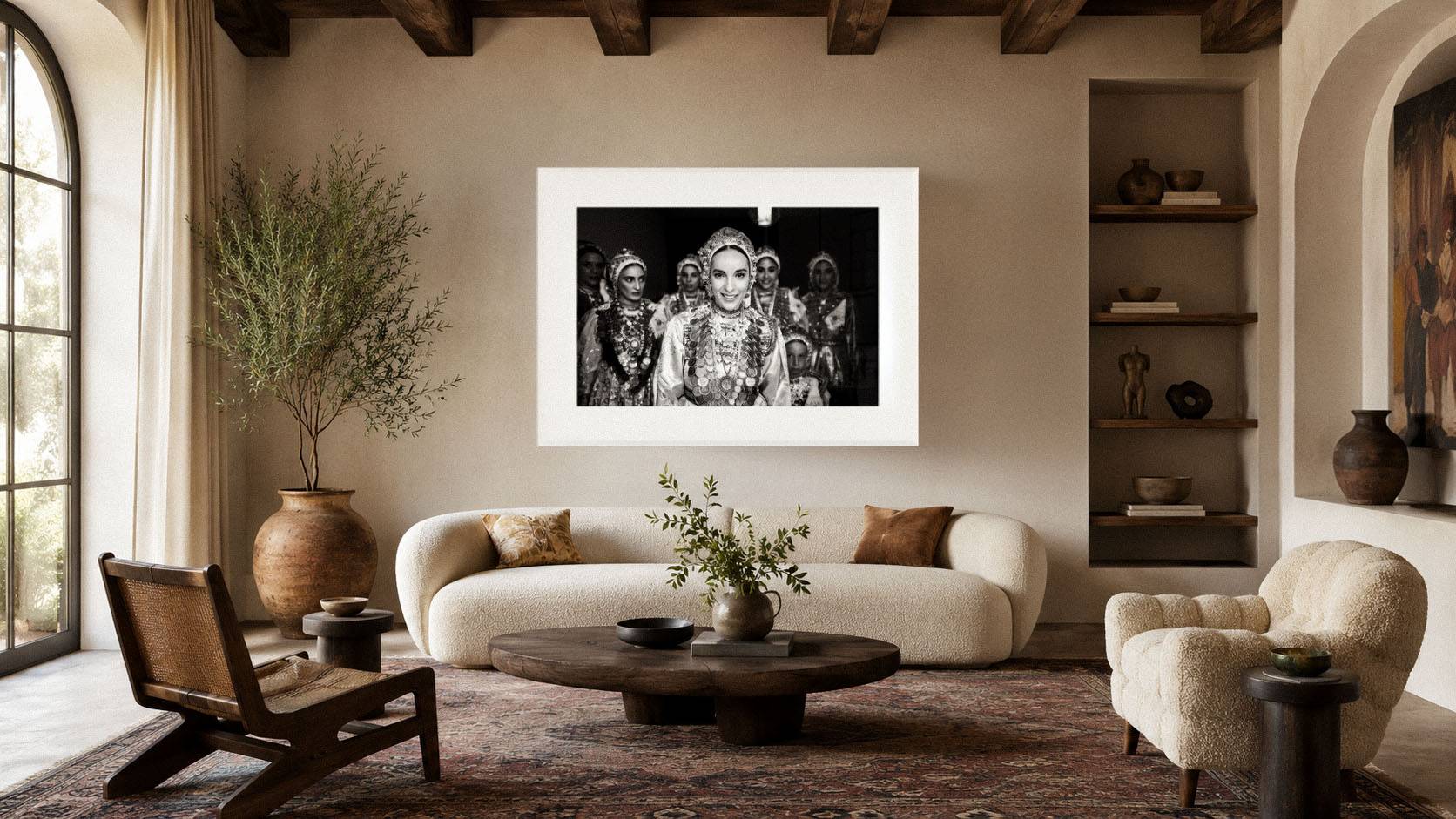 Black-and-white fine-art photograph displayed in a warm Mediterranean living room with textured walls, wooden beams, neutral furniture and traditional decorative elements.