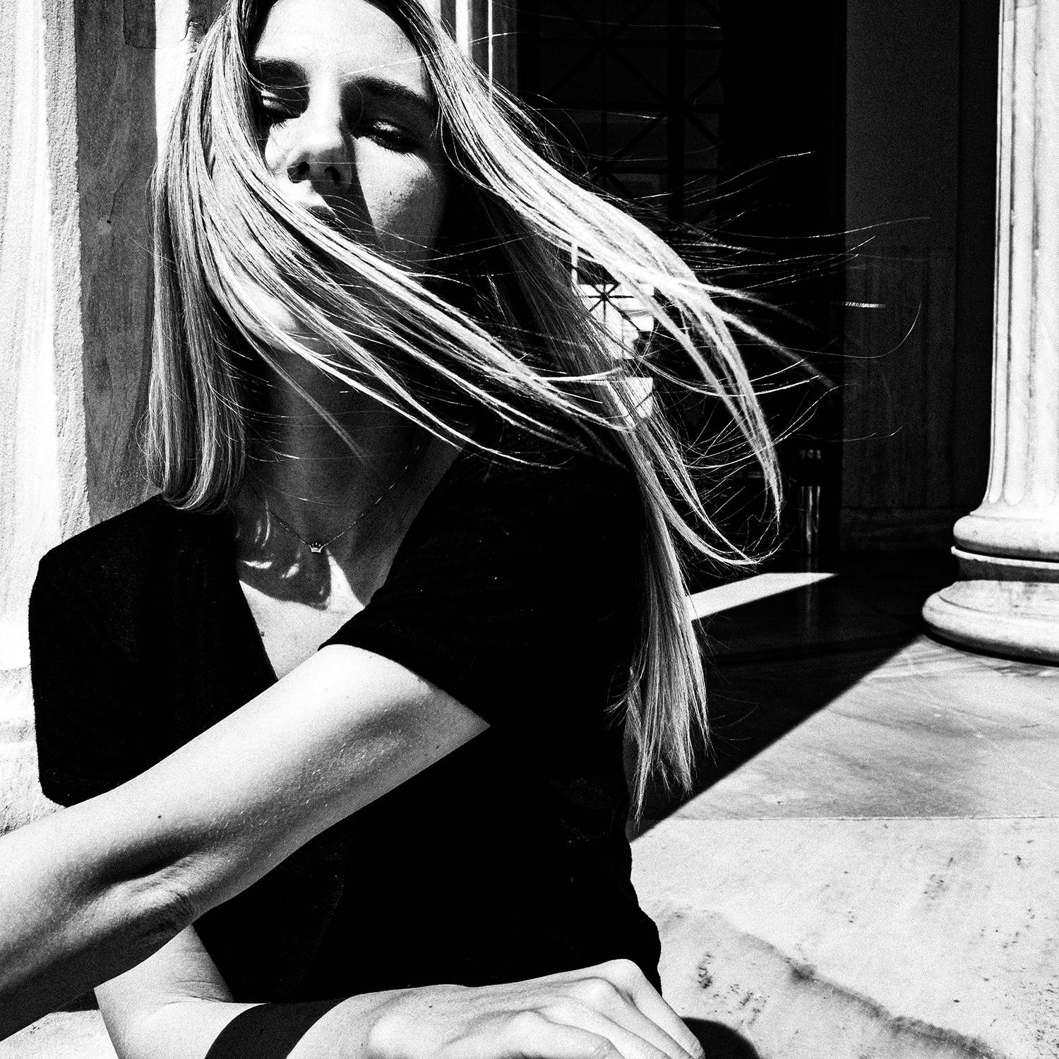 Black and white photograph of a model posing at the entrance of Zappeion in Athens, Greece