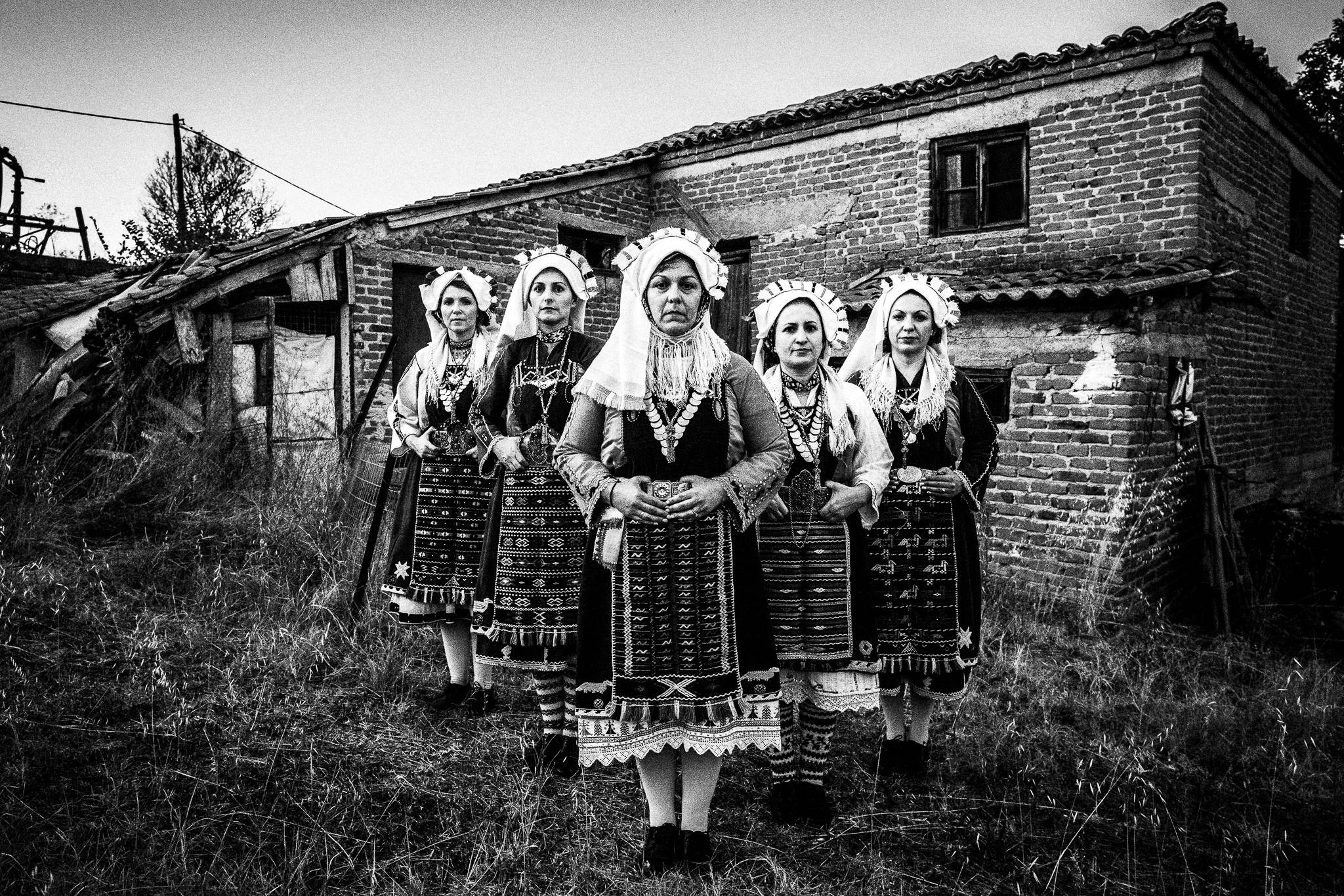 The ladies againsta brick wall at a traditional house nearby in Mani, Evros, Thrace, Greece, by photographer George Tatakis