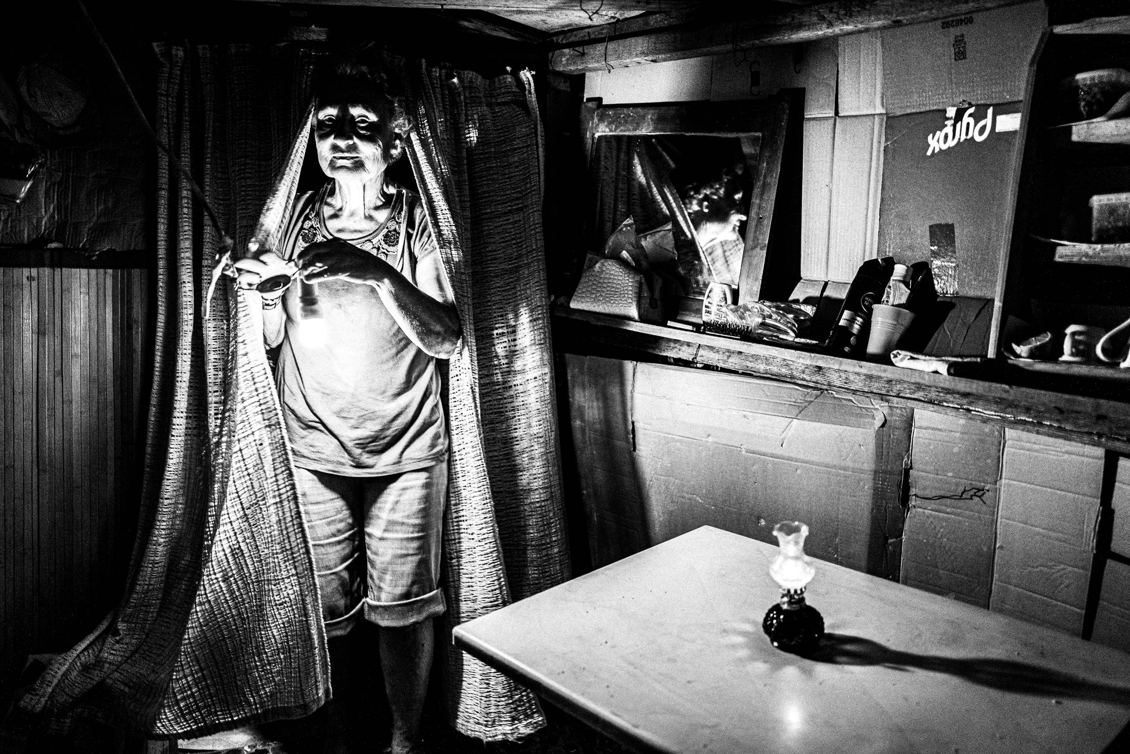 Inside one of the huts, during the celebration of Panagia Charakiani, Rethymnon, Crete, by photographer George Tatakis