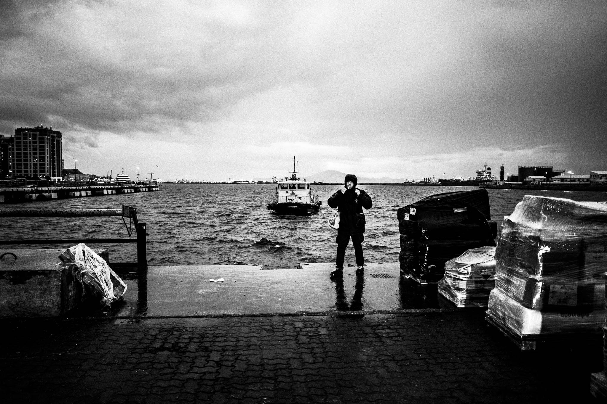 Mr. X in his raincoat waiting at the port, by photographer George Tatakis