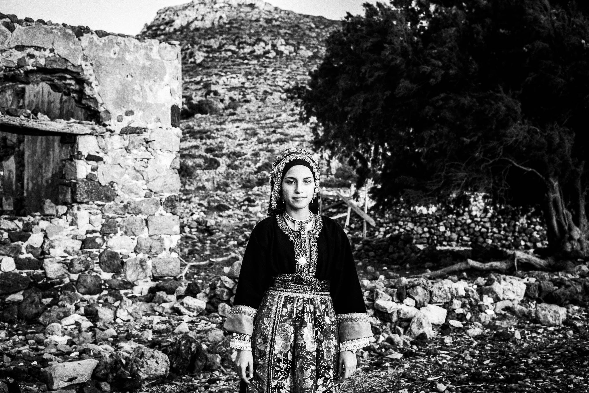 Girl in the traditional kava'e at the festival of Michael the Archangel at Tristomo, Olympos, Karpathos, Greece. Black and white photograph by George Tatakis