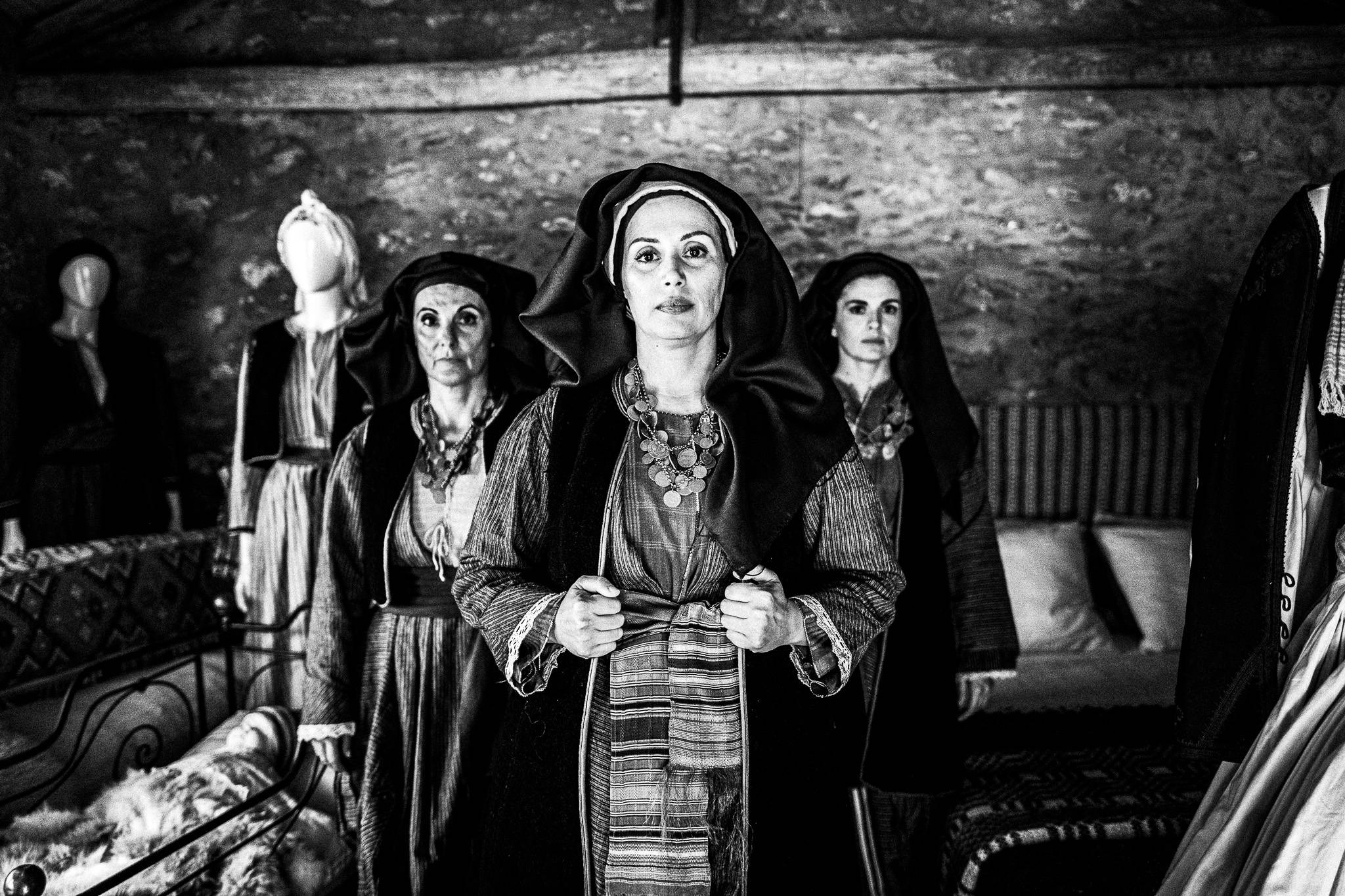 Three women in the traditional costumes of Alagonia, inside the house where Nikitaras was born, in the village of Nedoussa, Peloponnese, Greece