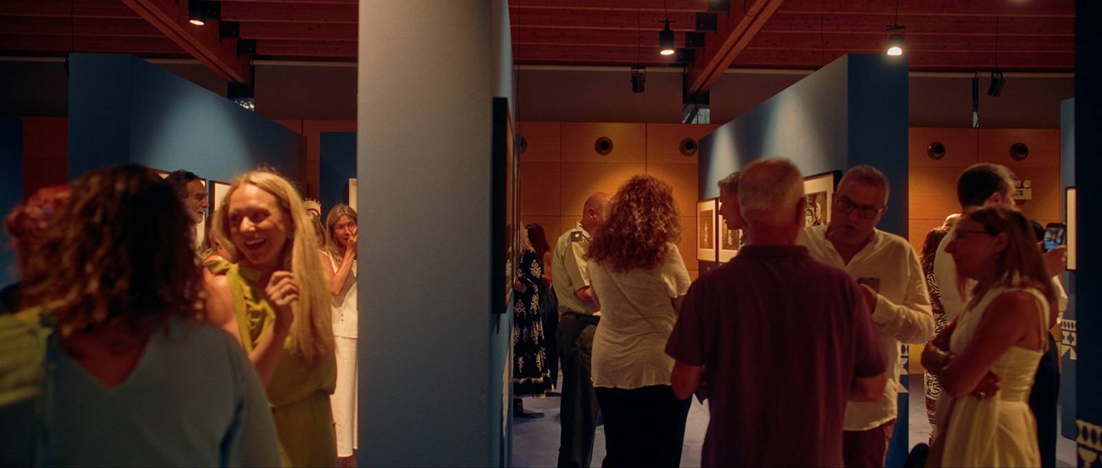 Visitors attending the opening night of the Caryatis Delta Chios photography exhibition at the Chios Mastic Museum.