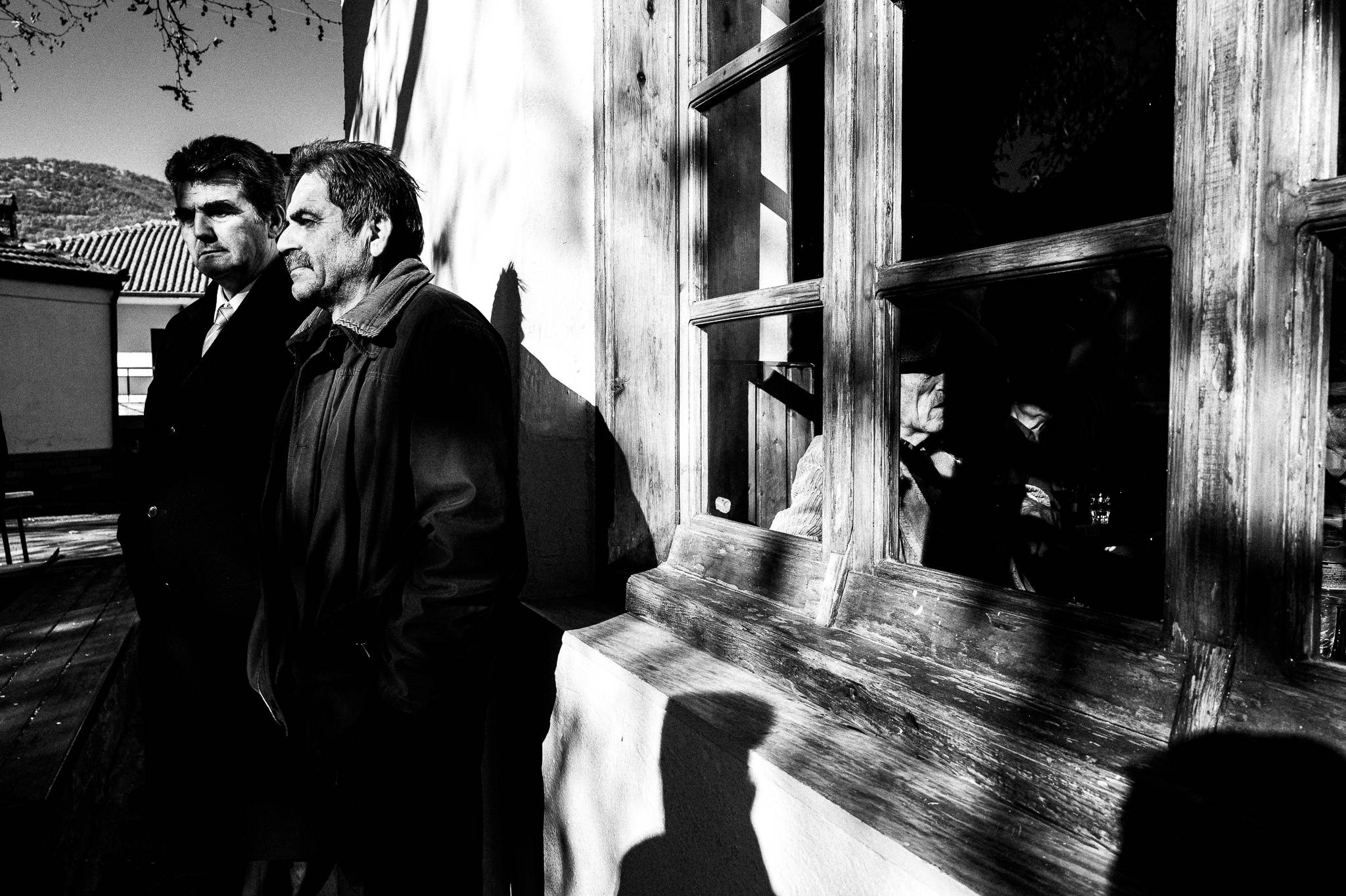 Outside the local café, Pagan Christmas customs of Northern Greece, by photographer George Tatakis