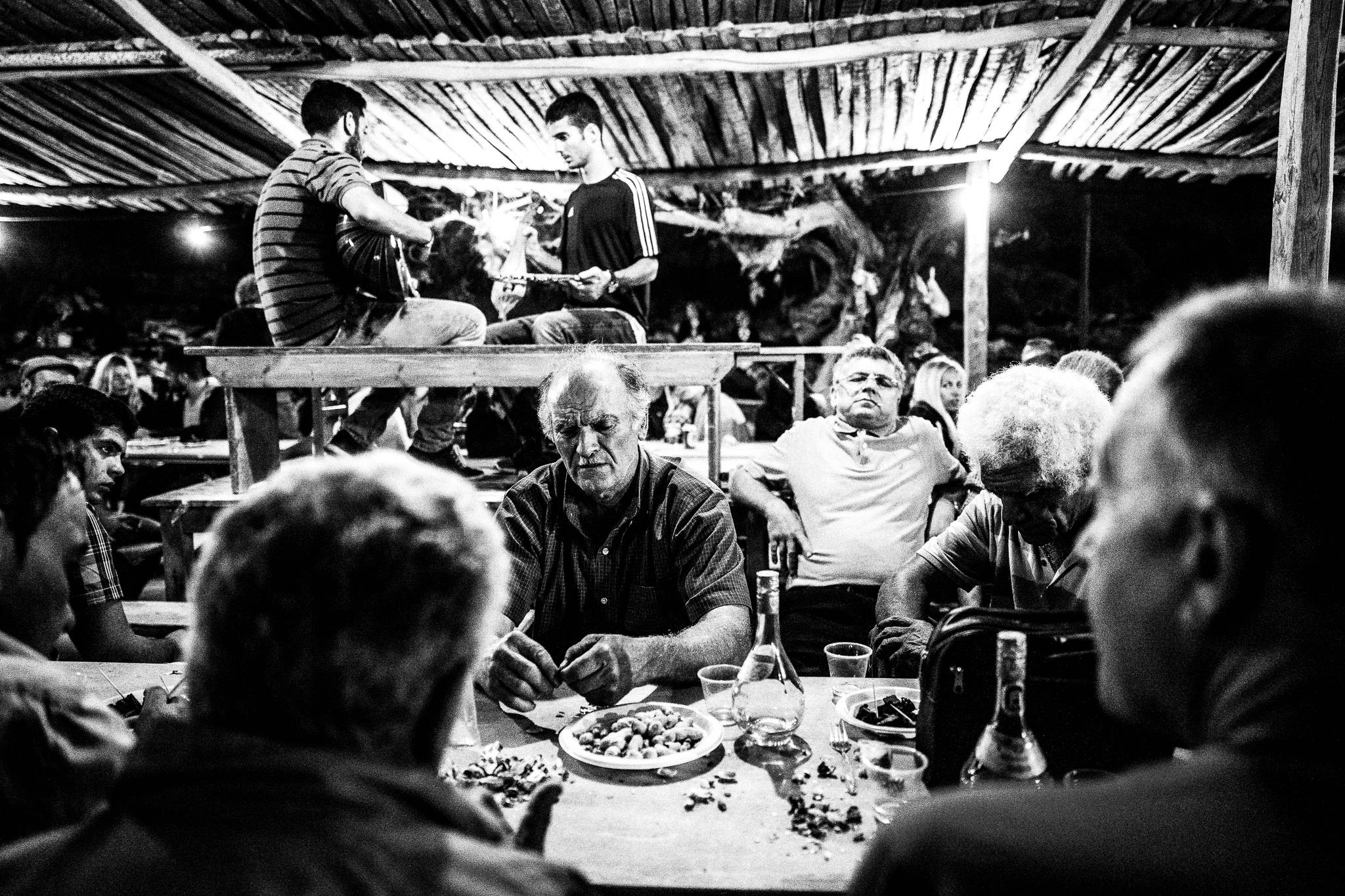Glentista'es at the feast of Saint John at the site of the ancient city of Brykous, Olympos, Karpathos, Greece. Black and white photography by George Tatakis